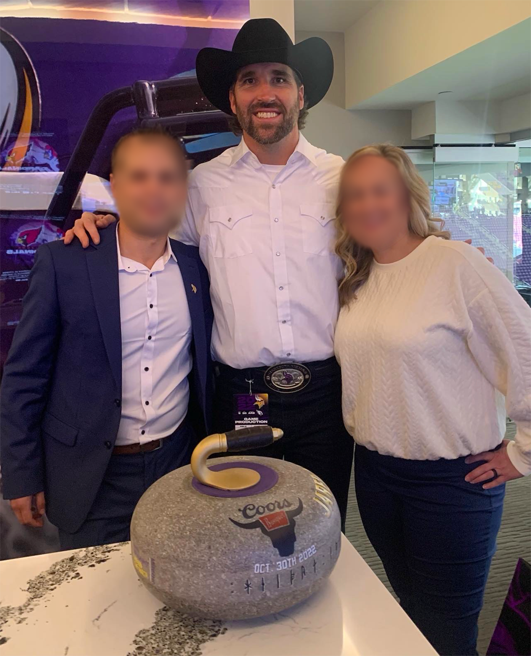 Jared Allen with Vikings staff delivering the curling stone!
