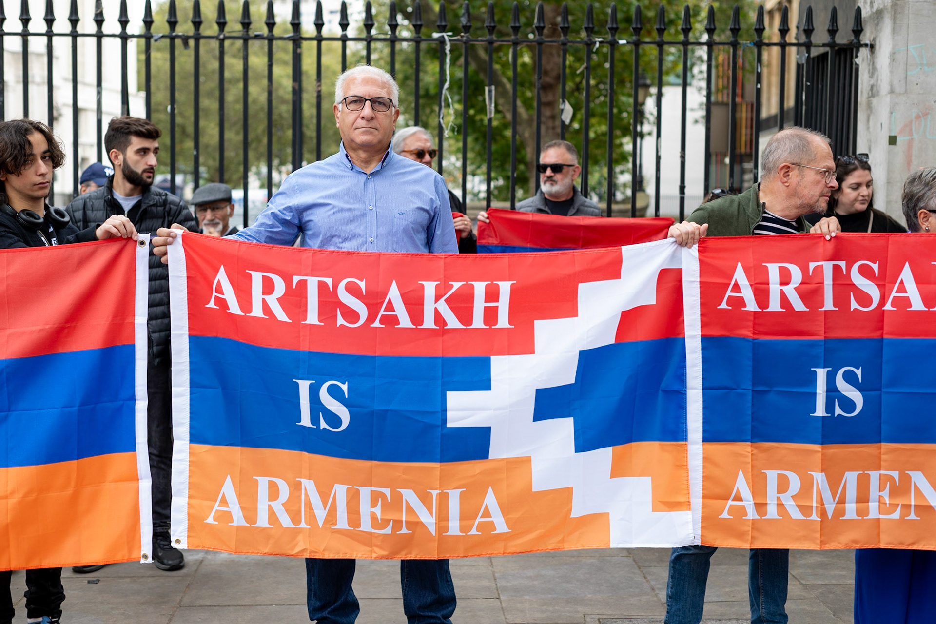 On September 30, 2023, at Downing St./EU Delegation Office, U.K., The United Committee of Armenian Organisation (ACCC) and the Diocese of the Armenian Church in the United Kingdom and Ireland gathered to denounce ethnic cleansing in the Republic of Artsakh (Nagorno-Karabakh). Bishop Hovakim Marukyan (not pictured) of the Diocese and representatives from the Armenian National Committee (ANC) were present. ACCC Chair Armand Abramiam (pictured) was instrumental in orchestrating the rally. The event occurred amid President Samwel Shrahramanyan's call to dissolve the Republic by January 1, 2024, a move met with skepticism about its authenticity, given concerns of possible coercion. Azerbaijan had declared complete control over the enclave.