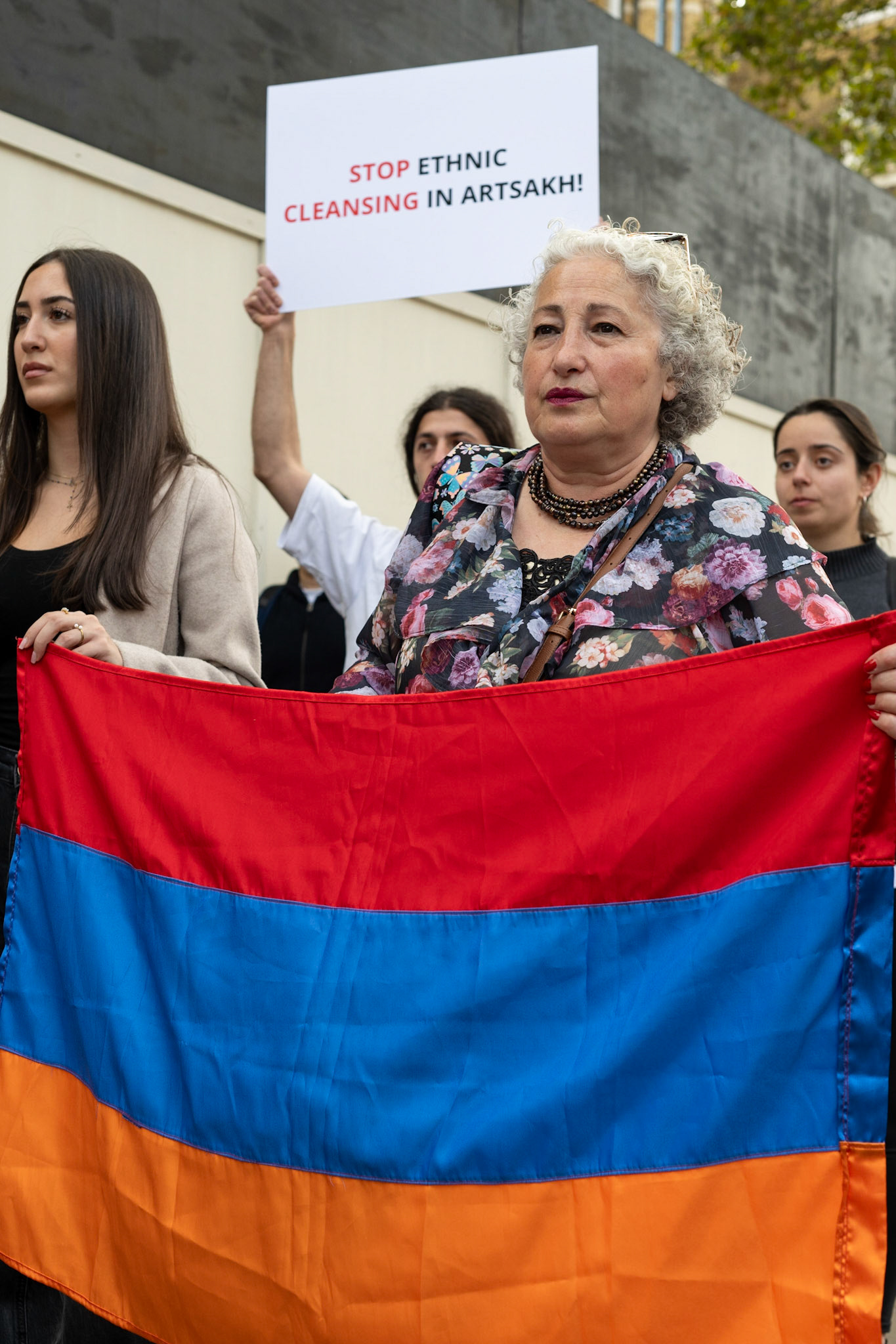On September 30, 2023, at Downing St./EU Delegation Office, U.K., The United Committee of Armenian Organisation (ACCC) and the Diocese of the Armenian Church in the United Kingdom and Ireland gathered to denounce ethnic cleansing in the Republic of Artsakh (Nagorno-Karabakh). Bishop Hovakim Marukyan (not pictured) of the Diocese and representatives from the Armenian National Committee (ANC) were present. Larissa (pictured, surname provided) spoke emtionally about her upbringing in Baku, living in Ukraine and now in the U.K. The event occurred amid President Samwel Shrahramanyan's call to dissolve the Republic by January 1, 2024, a move met with skepticism about its authenticity, given concerns of possible coercion. Azerbaijan had declared complete control over the enclave.