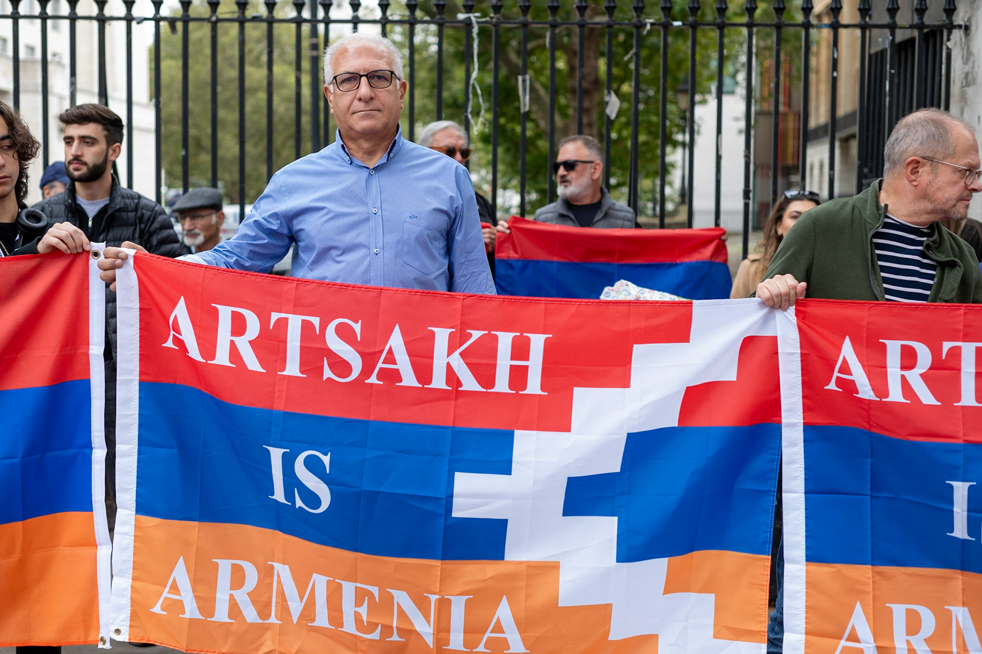 On September 30, 2023, at Downing St./EU Delegation Office, U.K., The United Committee of Armenian Organisation (ACCC) and the Diocese of the Armenian Church in the United Kingdom and Ireland gathered to denounce ethnic cleansing in the Republic of Artsakh (Nagorno-Karabakh). Bishop Hovakim Marukyan (not pictured) of the Diocese and representatives from the Armenian National Committee (ANC) were present. ACCC Chair Armand Abramiam (pictured) was instrumental in orchestrating the rally. The event occurred amid President Samwel Shrahramanyan's call to dissolve the Republic by January 1, 2024, a move met with skepticism about its authenticity, given concerns of possible coercion. Azerbaijan had declared complete control over the enclave.