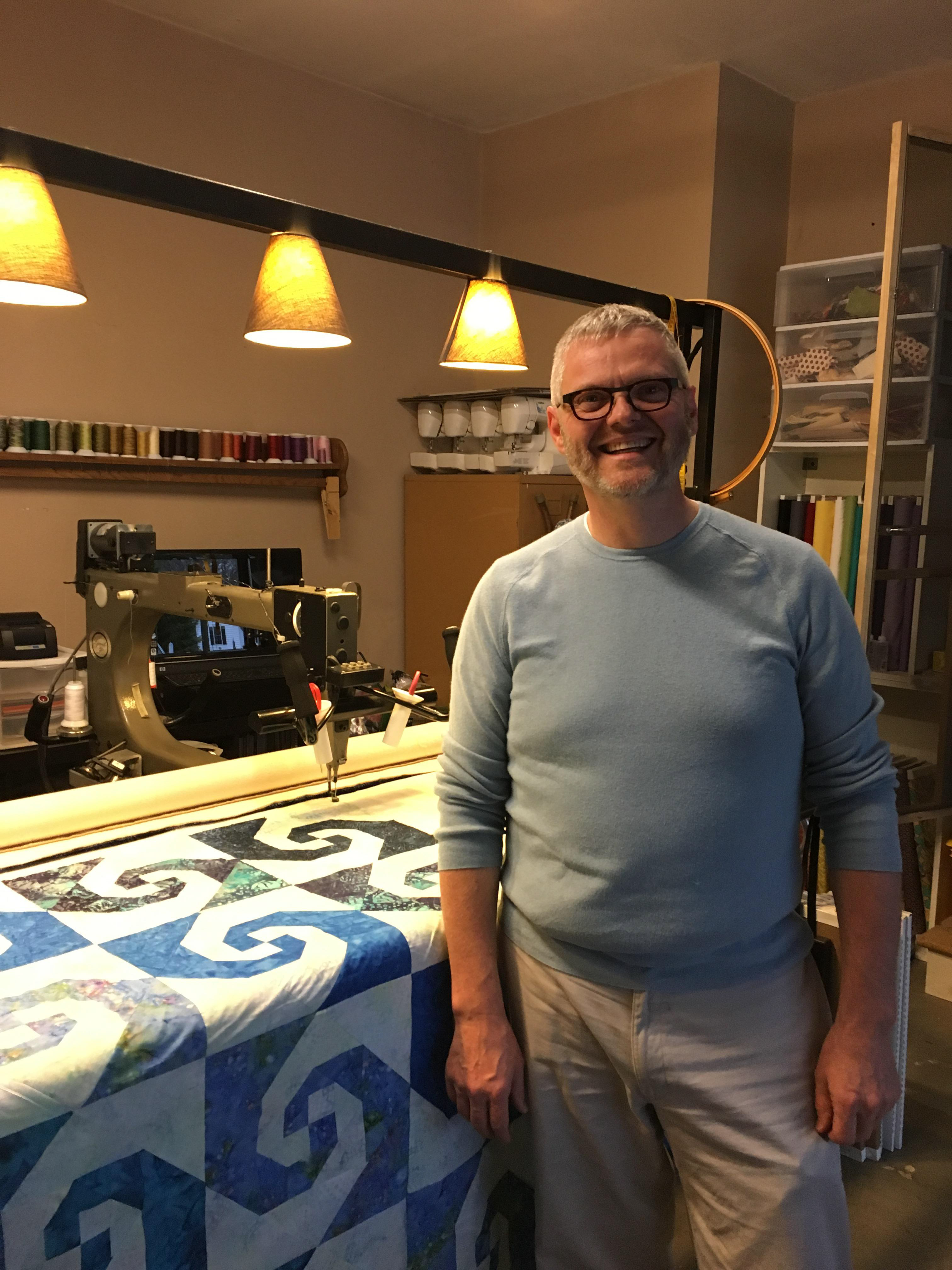Jim using a longarm quilting machine for the first time.