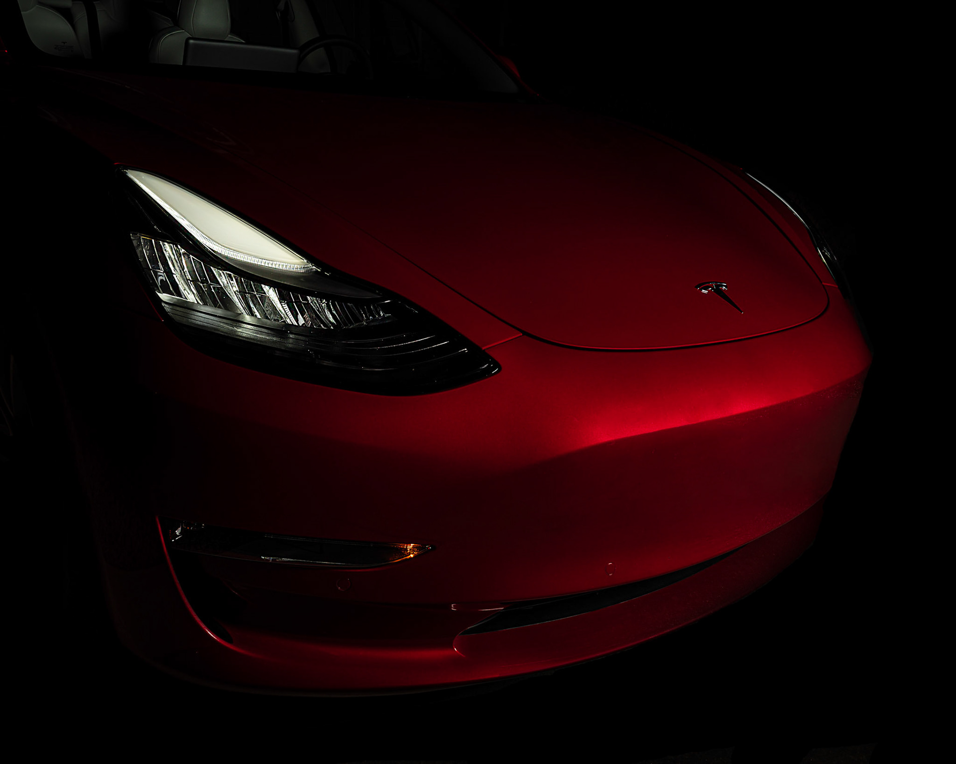 Red Tesla Model 3 at Night