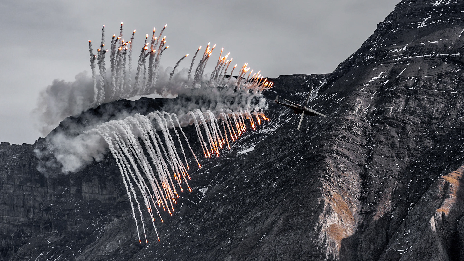 Swiss Air Force Super Puma Helicopter shooting flares at the Axalp life fire demonstration 2021