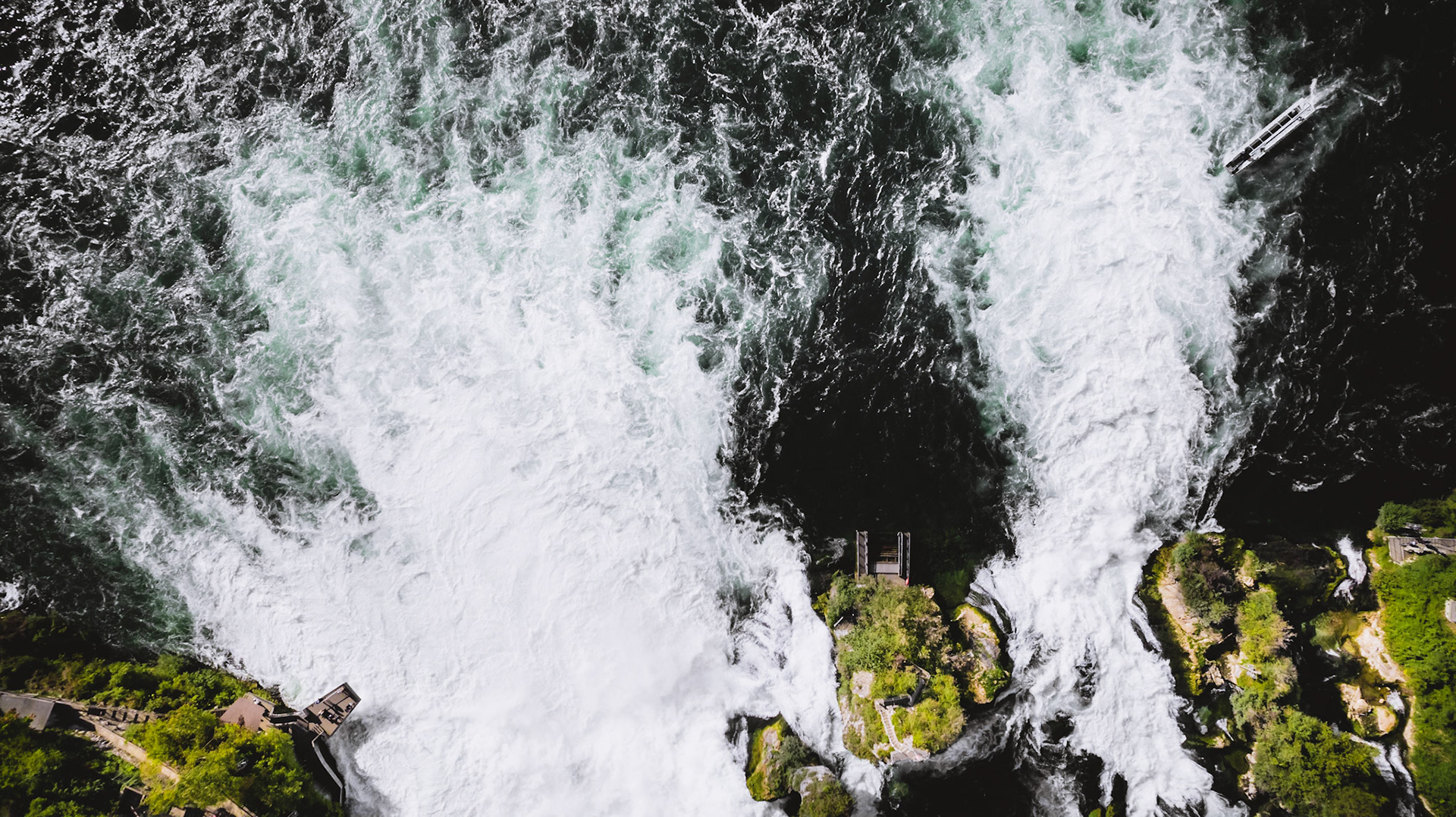 The Rhine Falls is a waterfall located in Switzerland and the most powerful waterfall in Europe. The falls are located on the High Rhine on the border between the cantons of Schaffhausen (SH) and Zürich (ZH). They are 150 metres wide and 23 metres high. In the winter months, the average water flow is 250 m3/s, while in the summer, the average water flow is 600 m3/s.