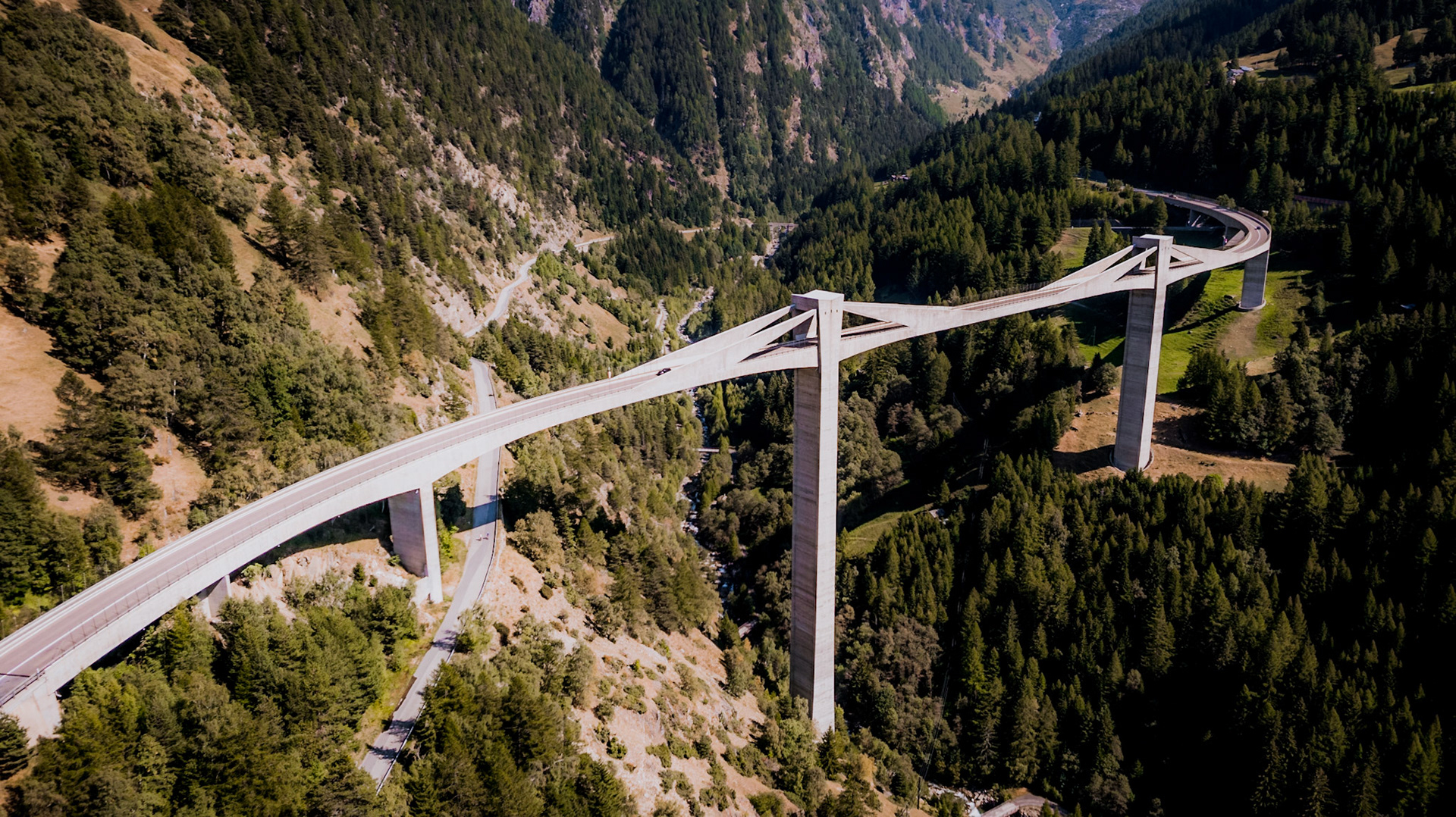 The Ganter bridge is part of the Simplon Pass road and the bridge with the biggest span length of Switzerland. Located about 6 miles south of Brig the bridge rosses over the river Ganter at 4780 ft. above sea level. The S-shaped bridge was designed by the architect Christian Menn and is 678 metres long. The Ganter bridge is visually intriguing because the angular shape contrasts with the surrounding landscape and looks like a gigantic sculpture out of a 70’s science fiction film.