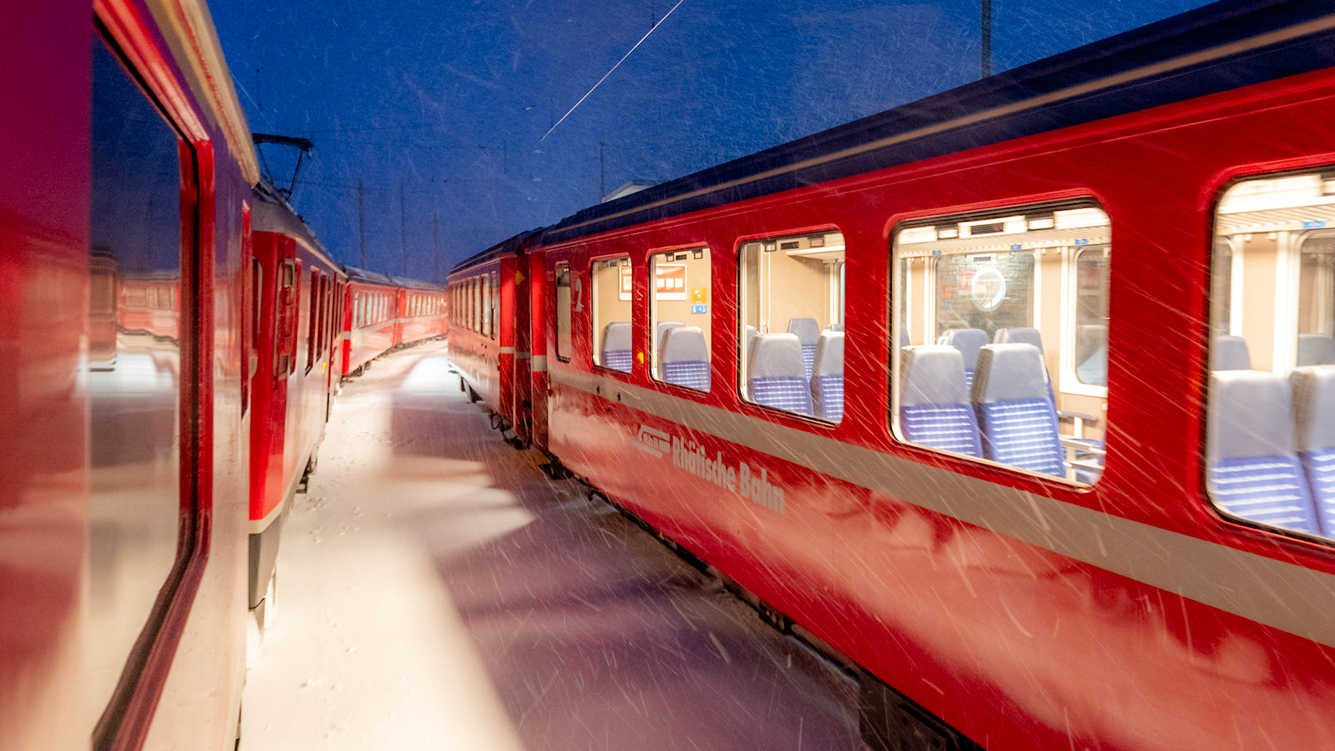 Two trains of Rhaetian Railways on the Bernina Line at Night