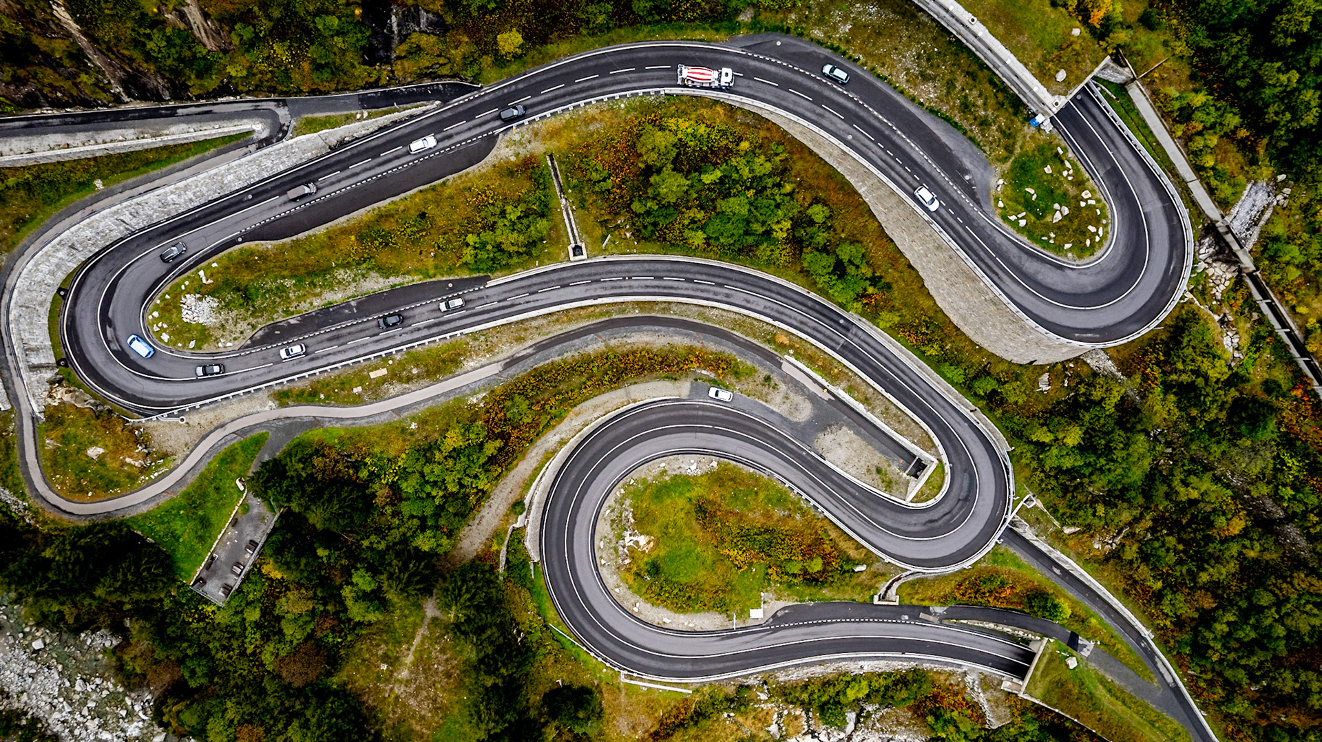 The Schöllenen Gorge is a gorge formed by the upper Reuss in the Swiss canton of Uri between the towns of Göschenen to the north and Andermatt to the south. It provides access to the St Gotthard Pass. Enclosed by sheer granite walls, its road and railway require several spectacular bridges and tunnels, of which the most famous is a stone bridge known as the Teufelsbrücke ("Devil's Bridge").
