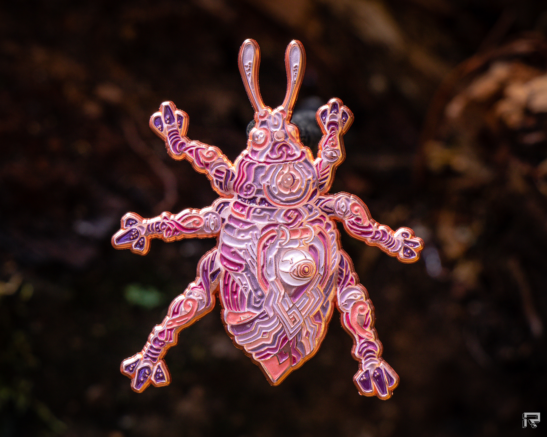 Enamel pin of a beetle with copper metal mechanical details