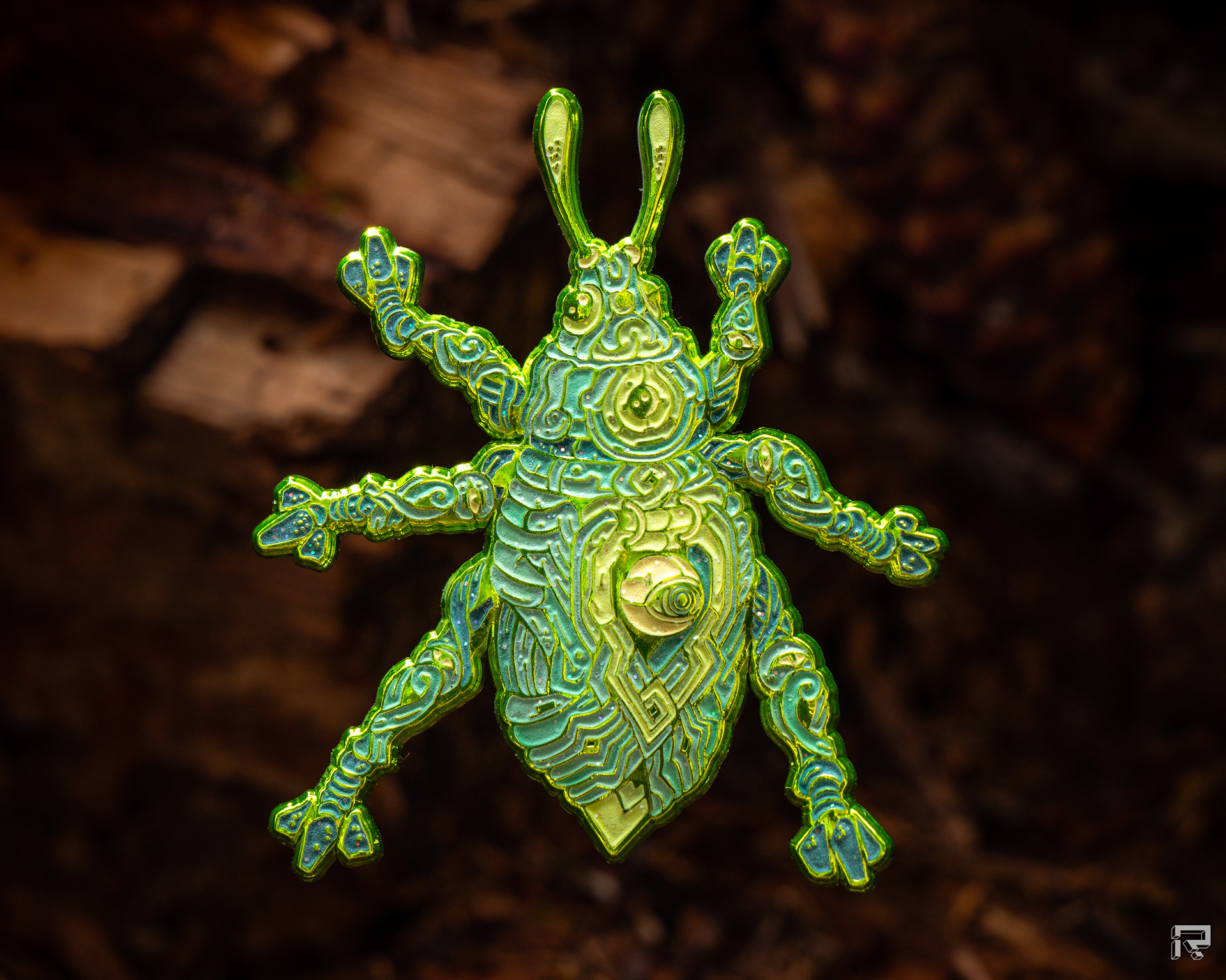 Enamel pin of a beetle with green metal mechanical details