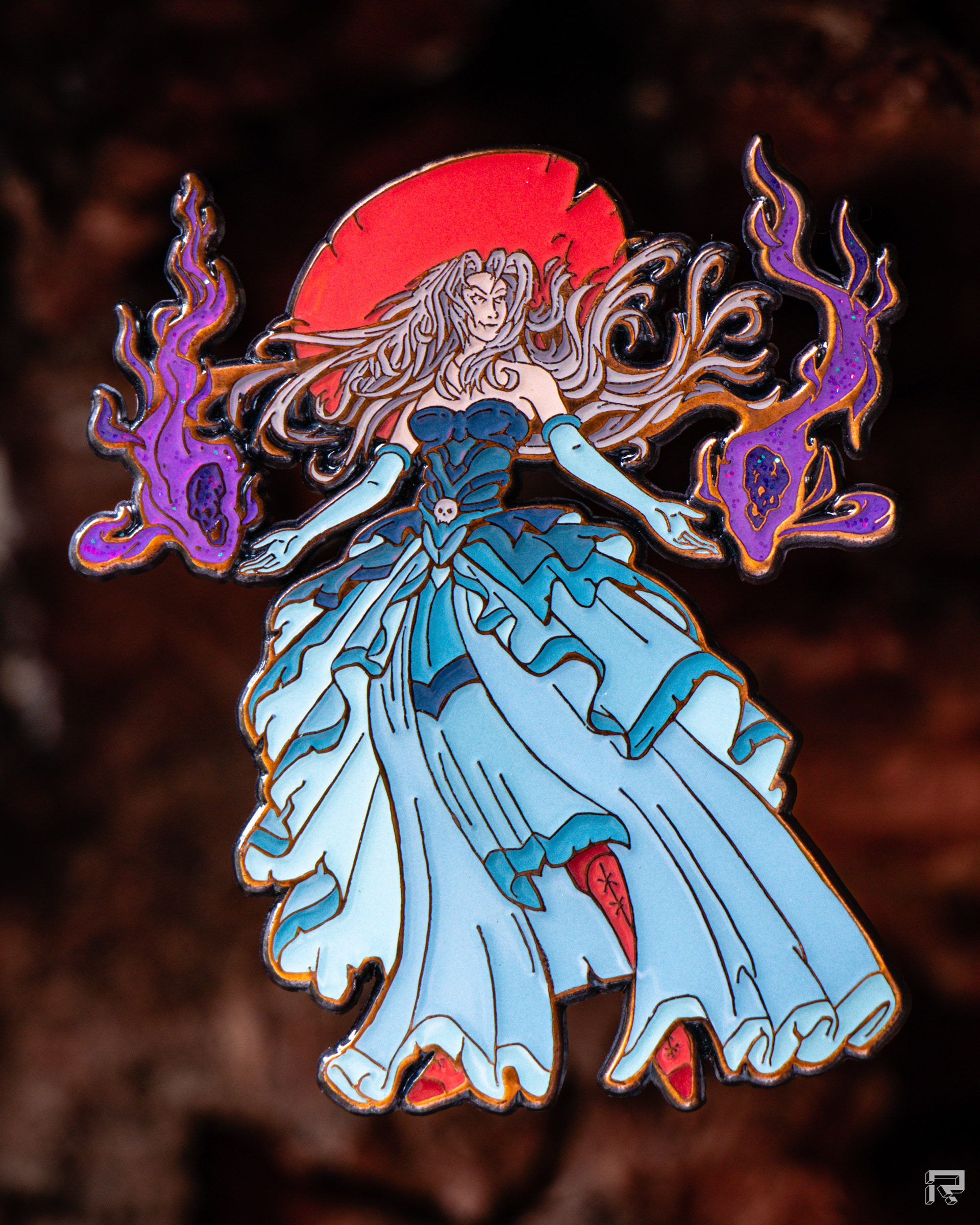 Enamel pin of a beautiful enchantress, long billowing black dress, two skulls with flames float above either hand, dynamic flowing silver hair, antique copper metal