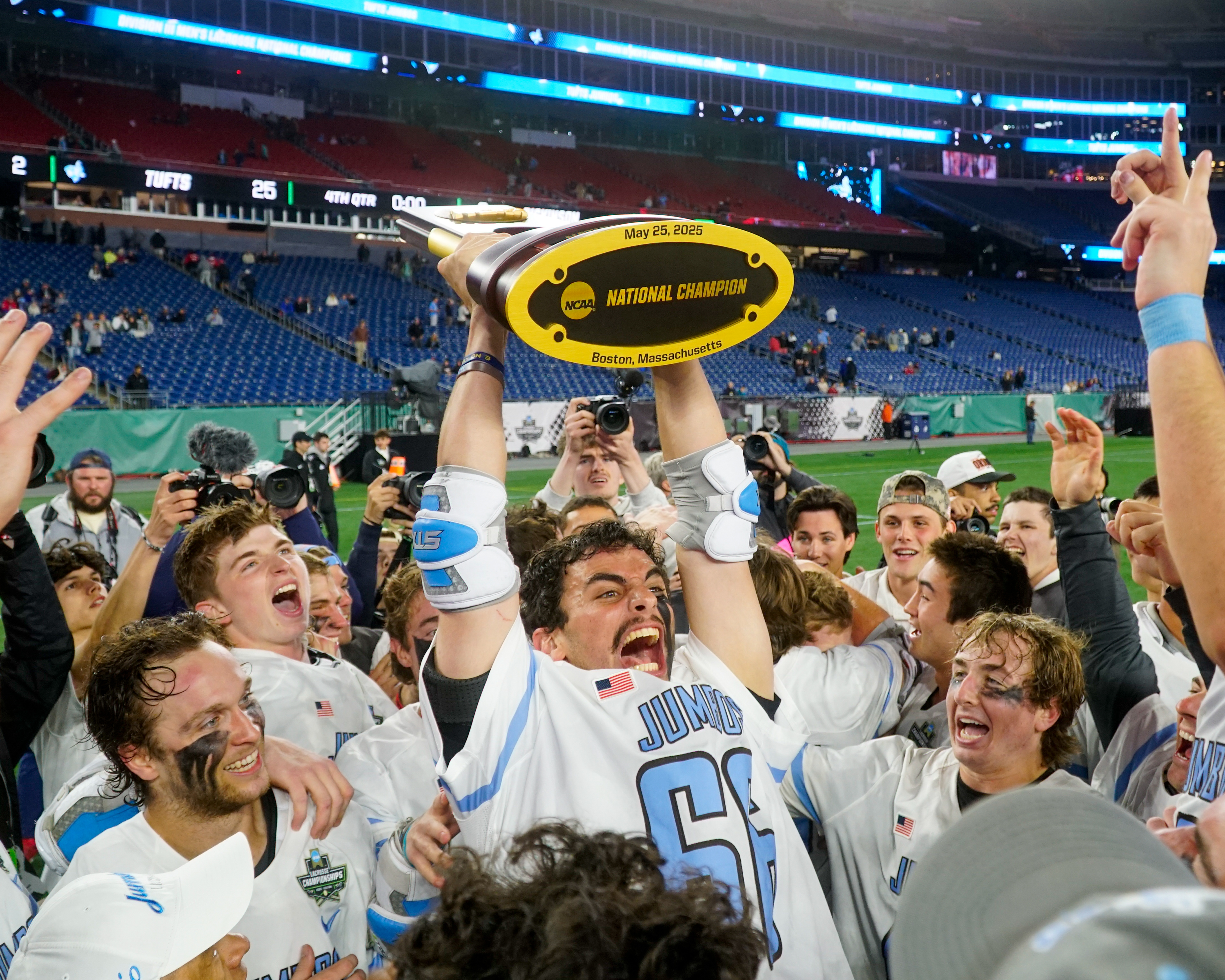 Tufts senior Braun Lippe hoists the trophy after a 25-8 win over Dickinson in the NCAA Division 3 men's lacrosse national title game on May 25, 2025 at Gillette Stadium in Foxborough, Mass.