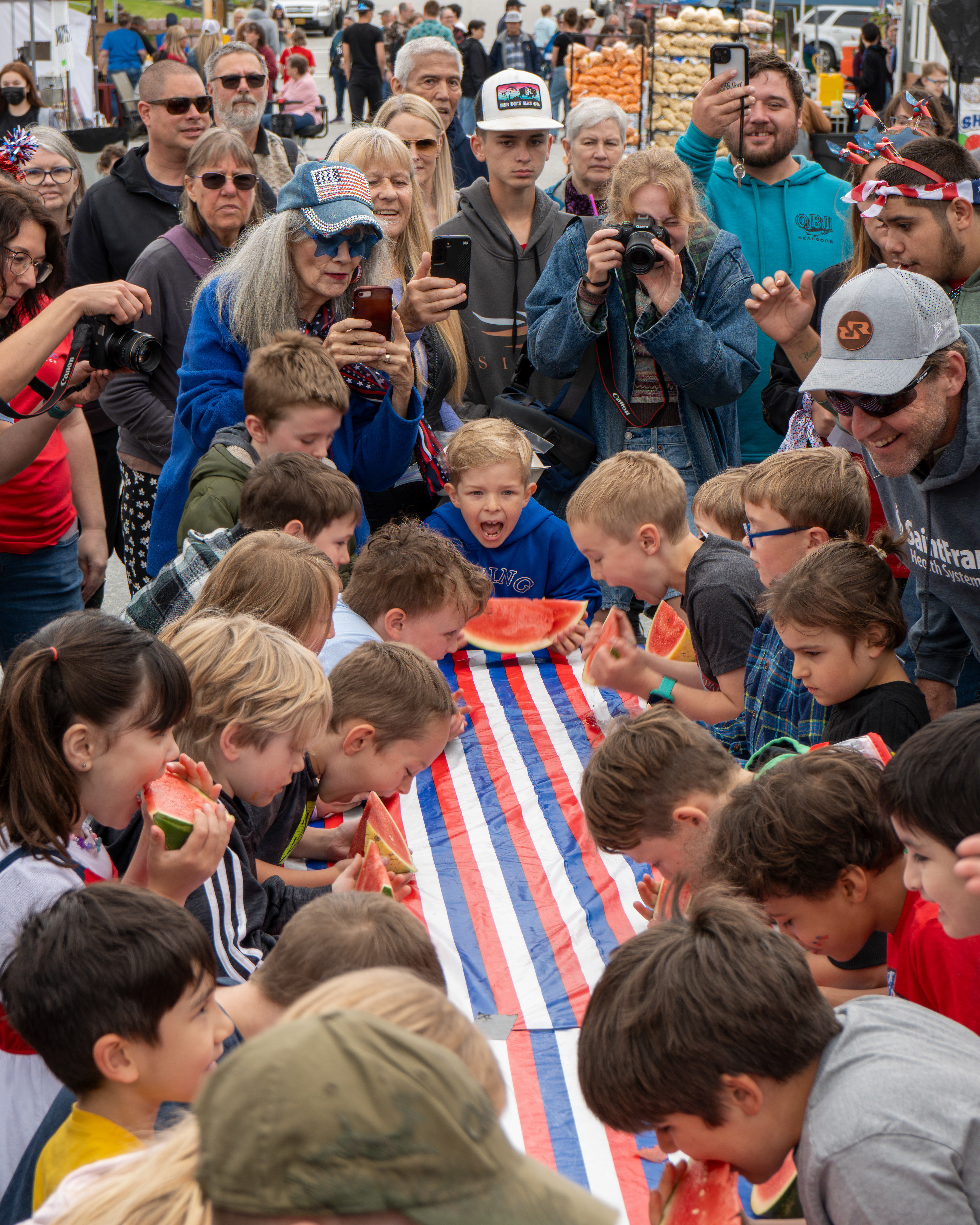 Parents gather as young children compete in the 10th annual watermelon-eating contest on July 4, 2025 in Petersburg, Alaska.