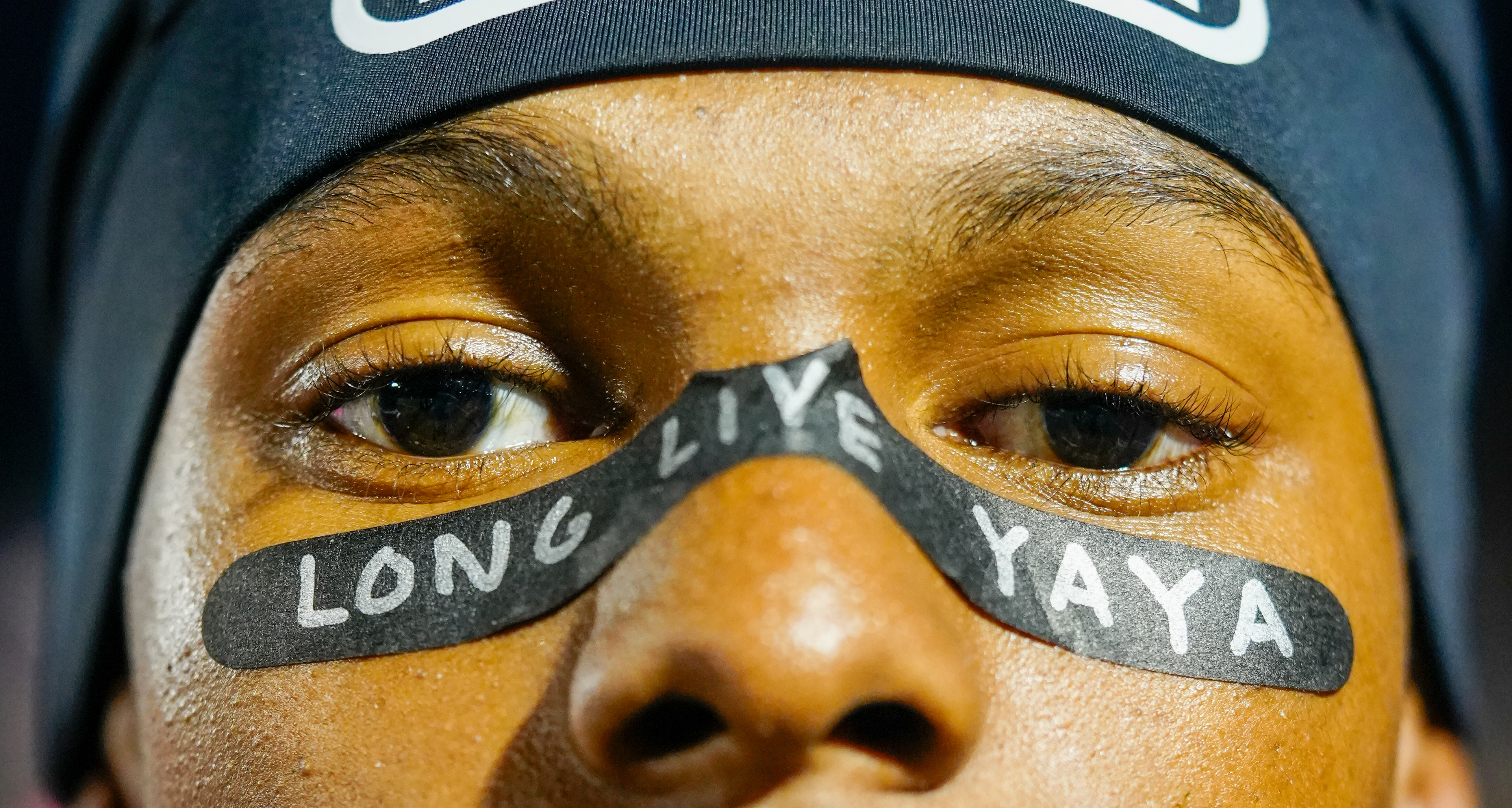 Hickman senior Marcus Johnson wears face tape reading "Long Live Yaya" at a game against Rock Bridge on Oct. 17, 2025 at Hickman High School in Columbia, Mo. Johnson paid tribute to Stephens College student Aiyanna Williams, who was killed last month in a shooting in downtown Columbia. Williams was the daughter of Hickman coach Marvin Williams.