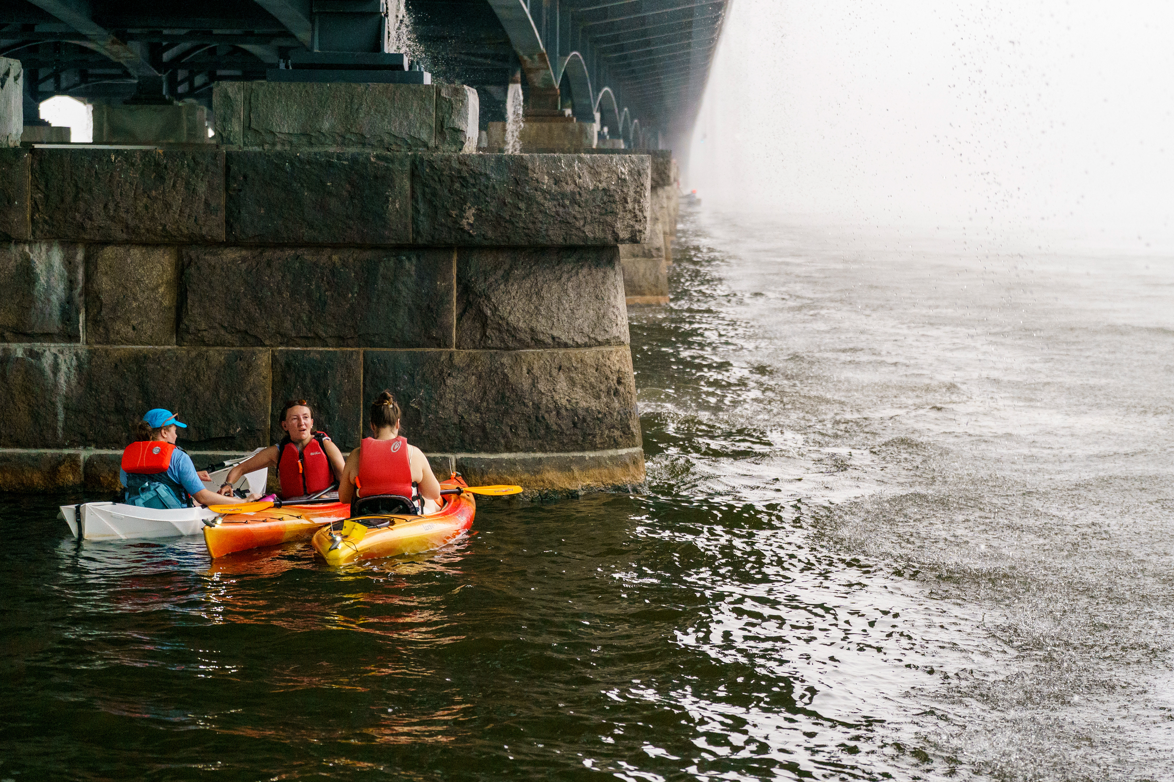 Kayakers on the Charles River sheltered under Harvard Bridge during a brief downpour on July 4, 2026 in Boston.