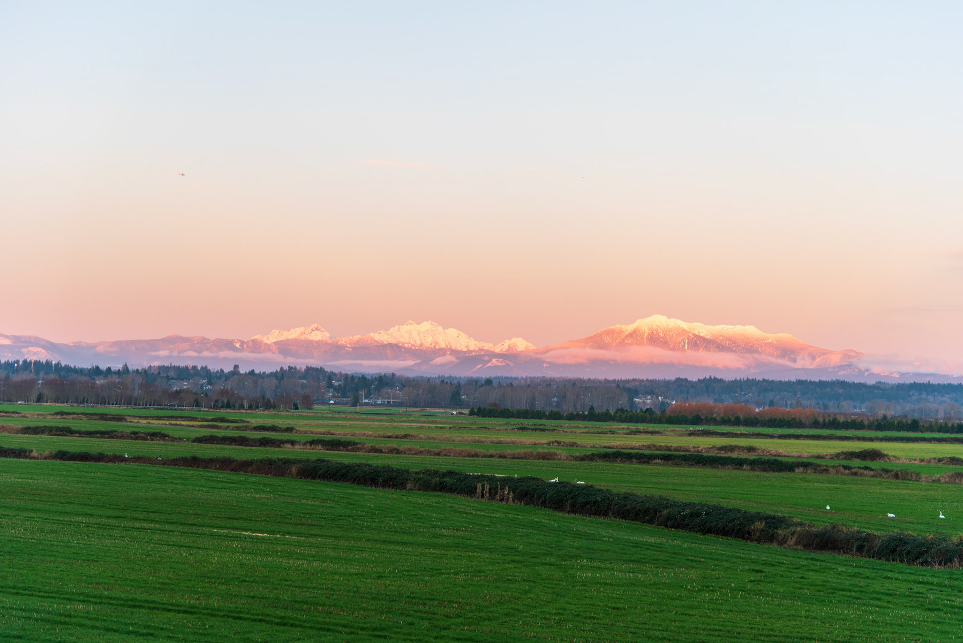 The Cascade mountains with Snohomish in foreground at sunset in December