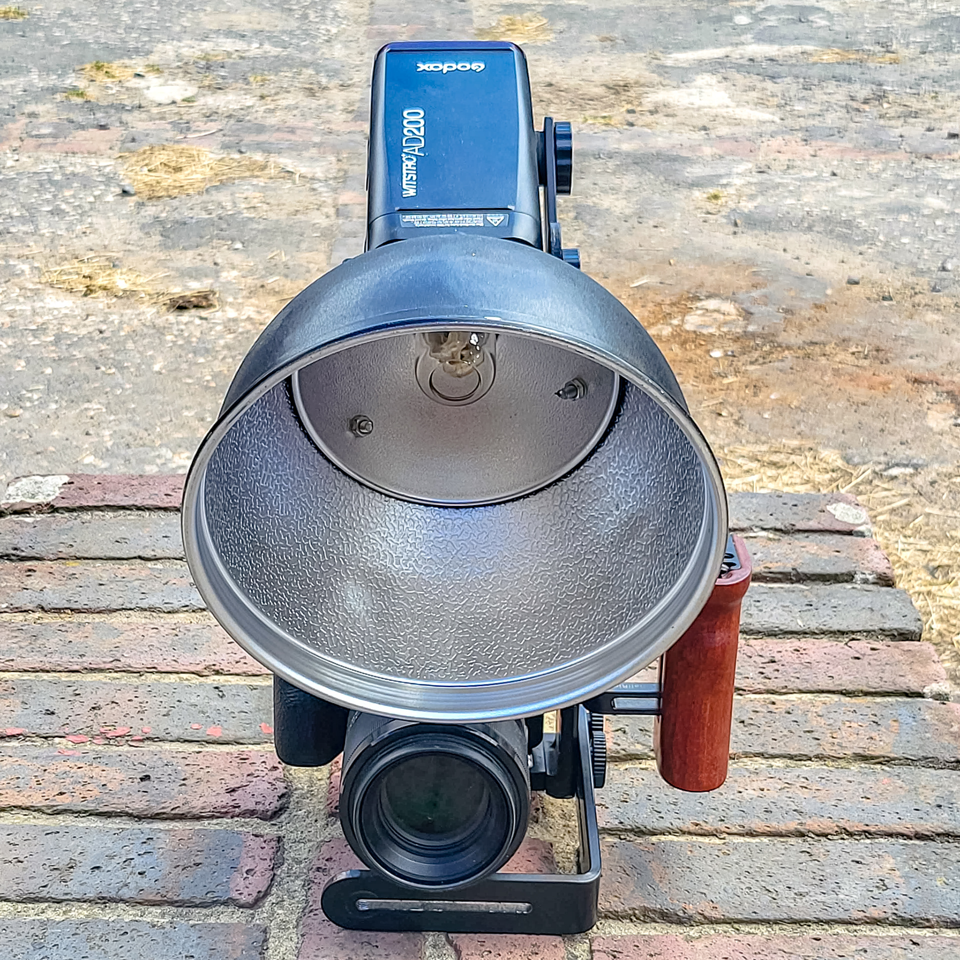 20cm Bowens reflector bolted to Godox AD-S2