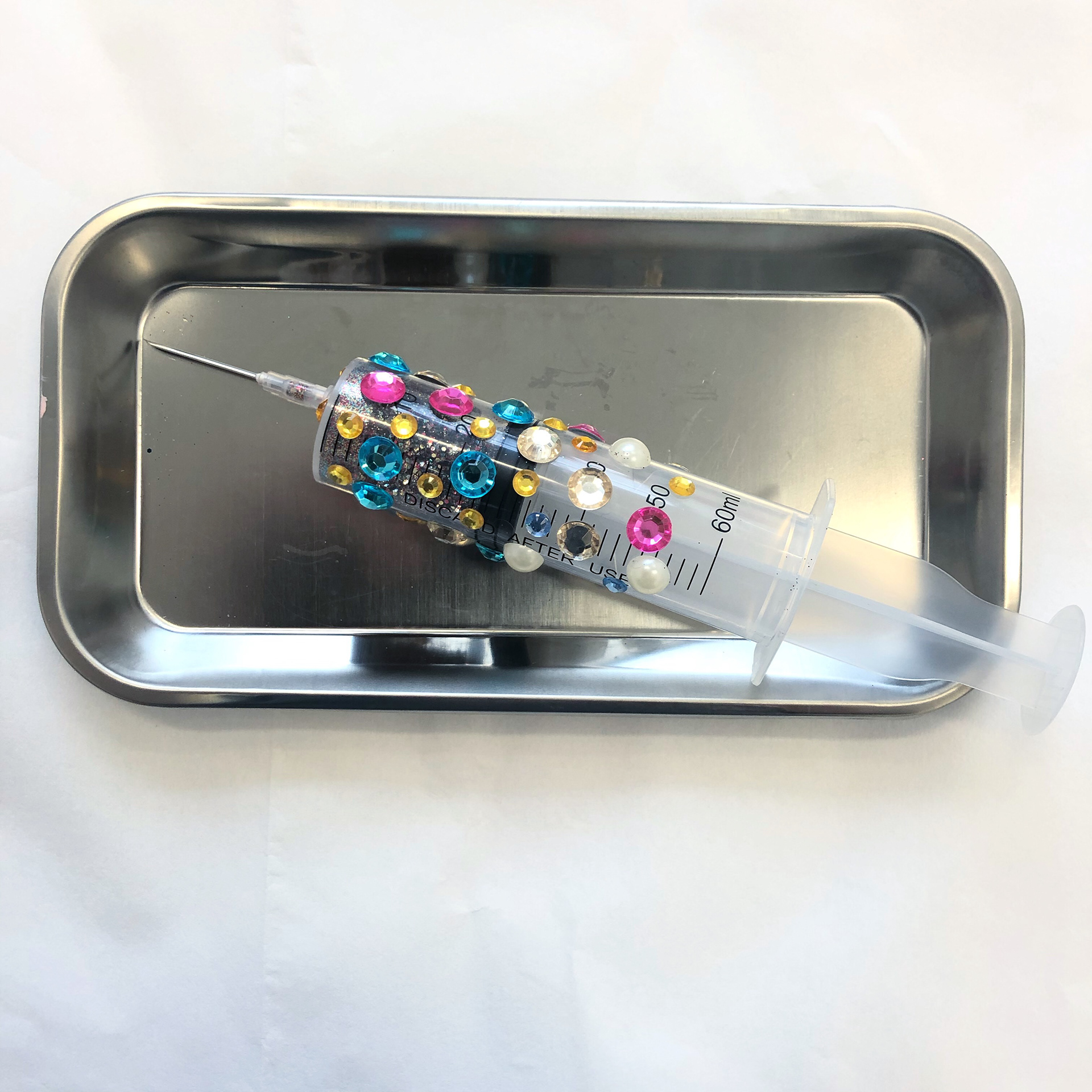 Beauty Shot, 2019. syringe, glitter, gems, metal.
