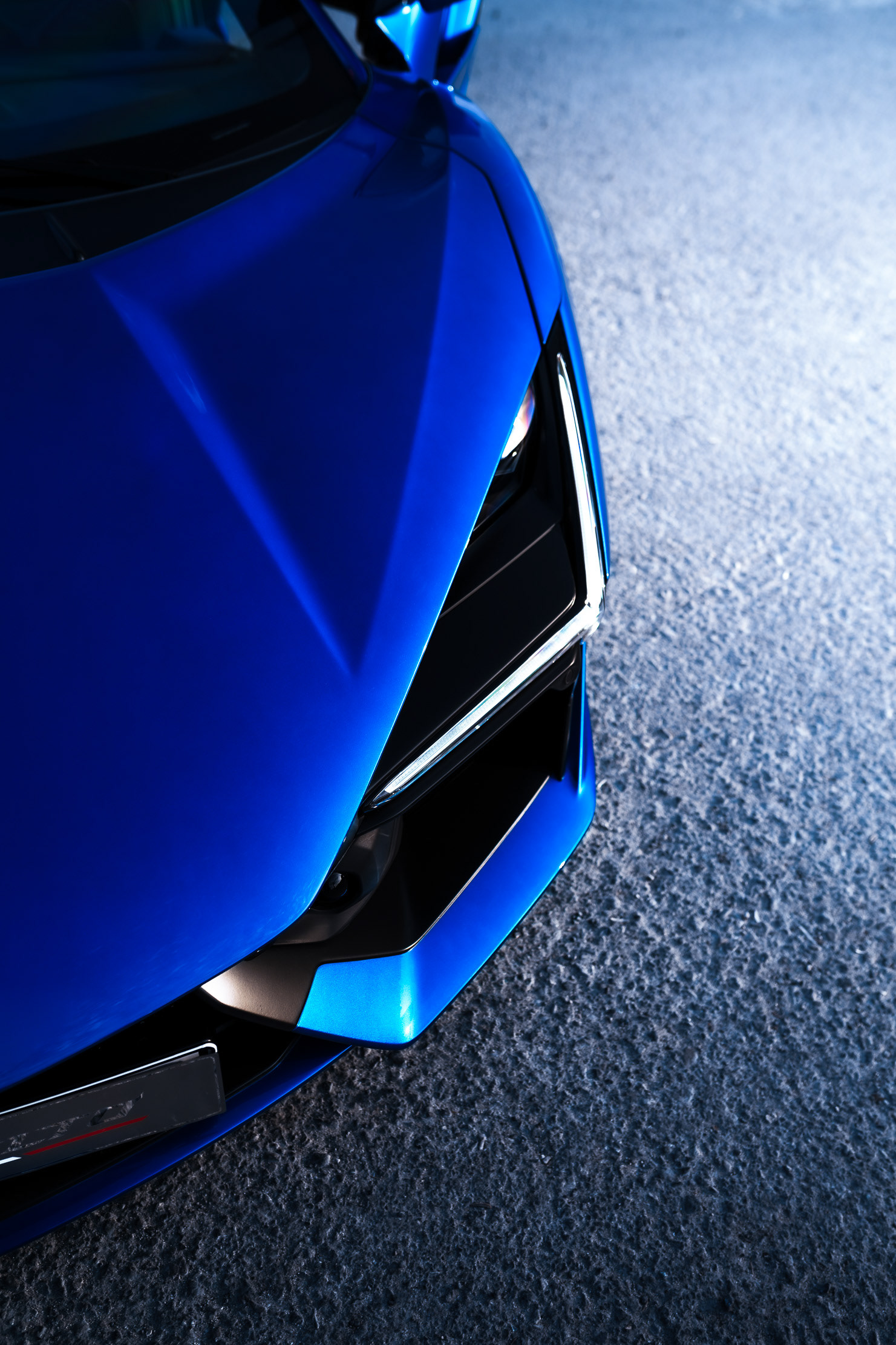 Lamborghini Revuelto front headlight and bumper detail in blue