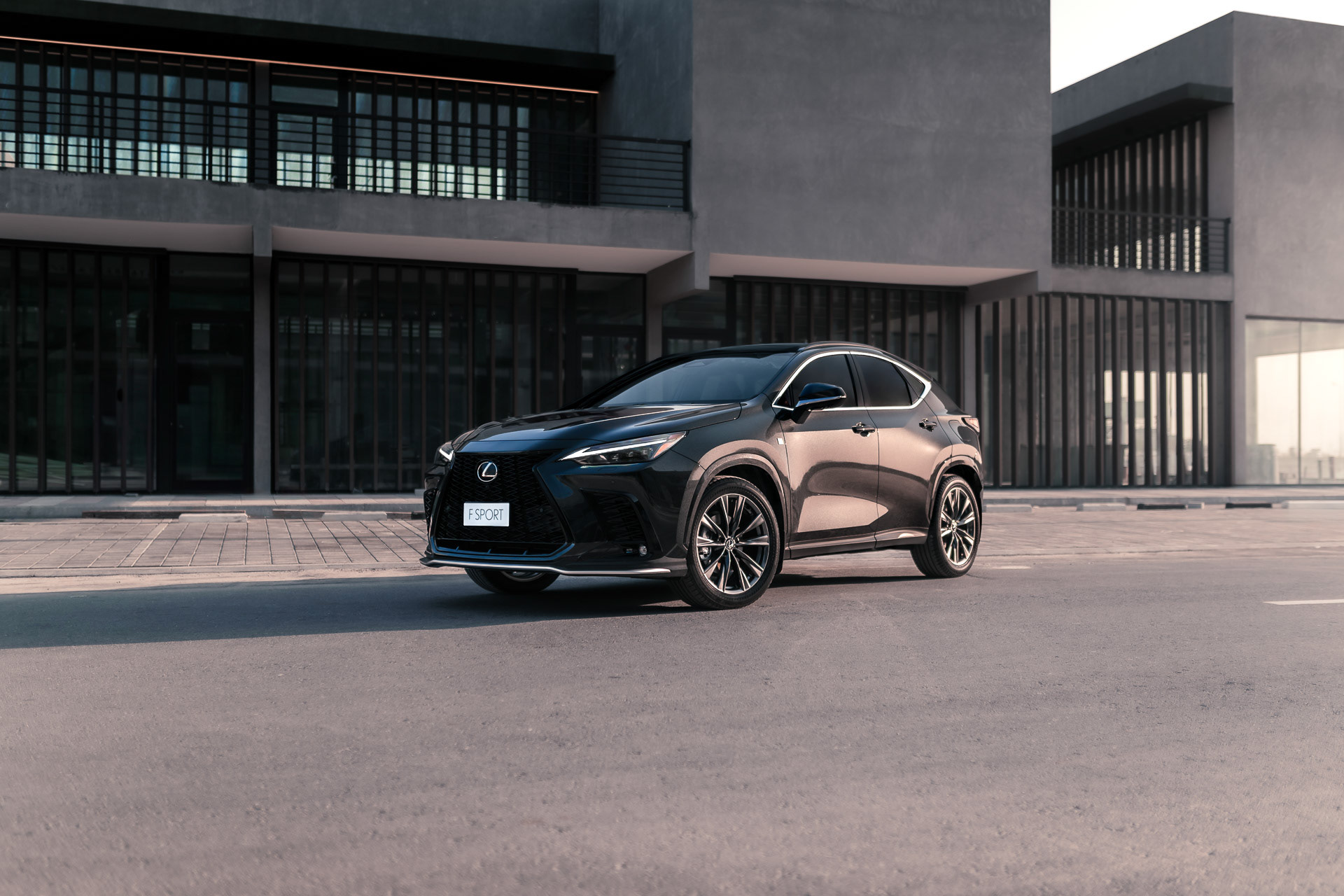Close front shot of Lexus NX F Sport parked near modern building architecture