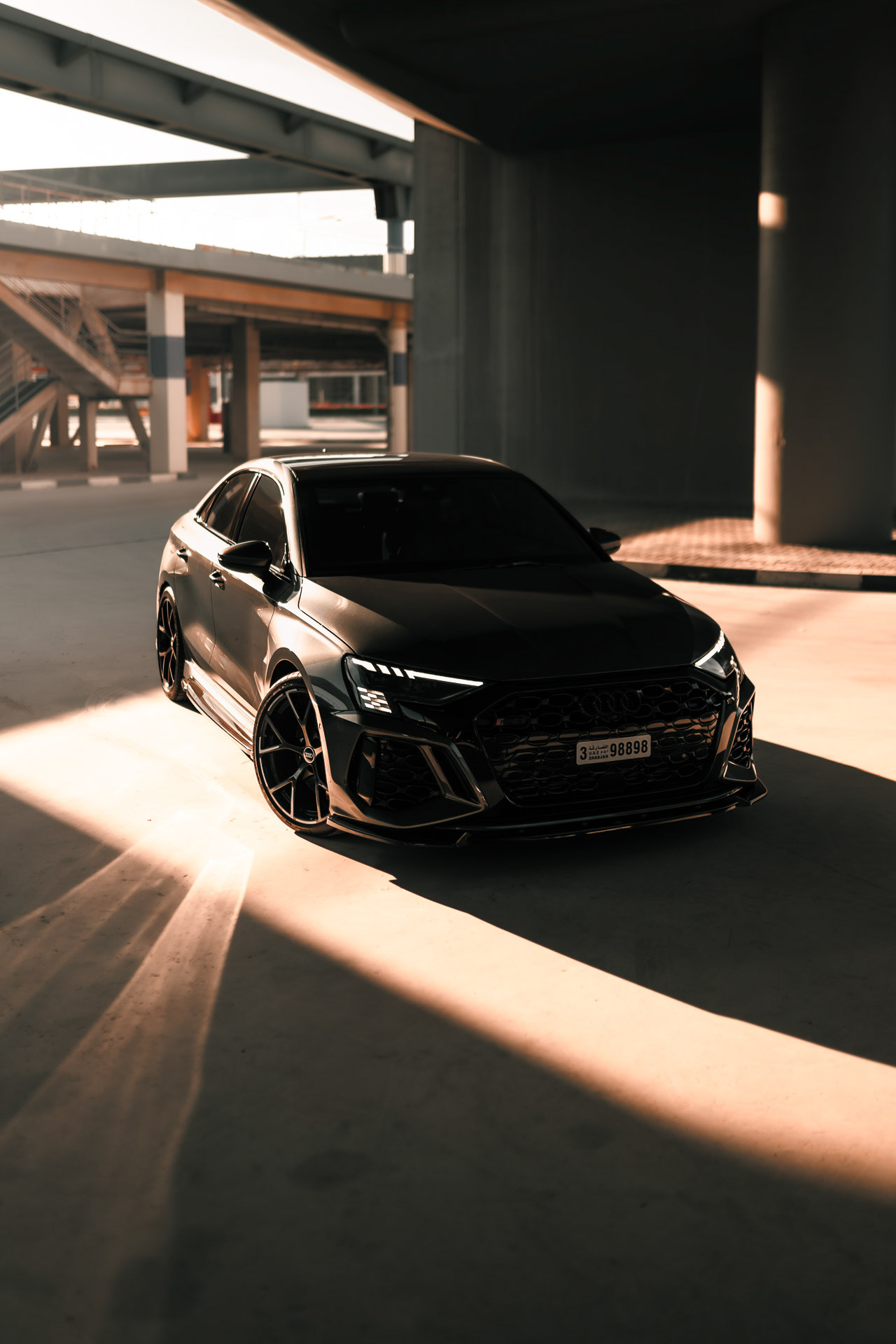 Audi RS3 2023 front view in Dubai parking structure with directional light and shadows