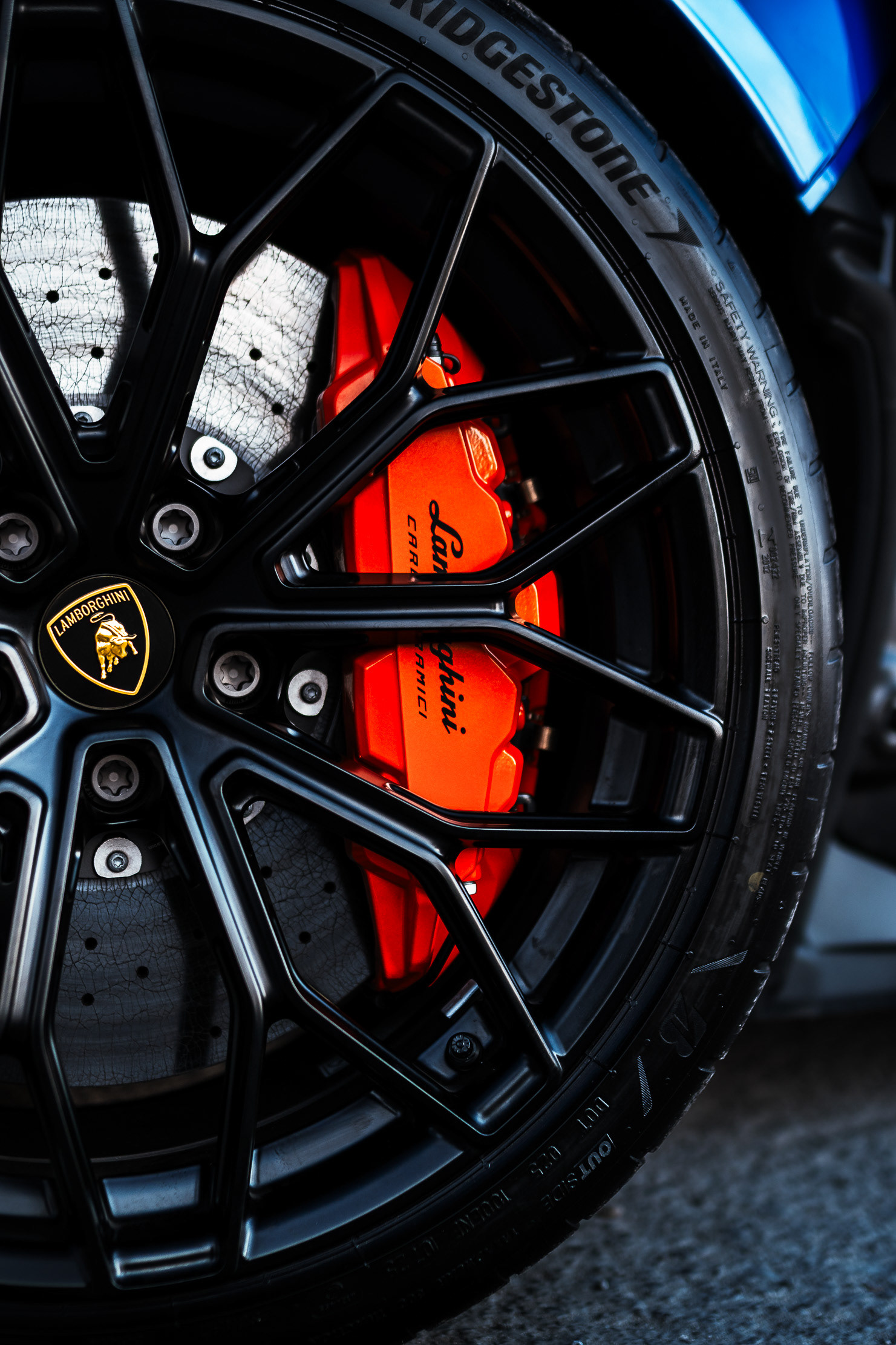 Lamborghini Revuelto wheel and orange carbon-ceramic brake caliper detail