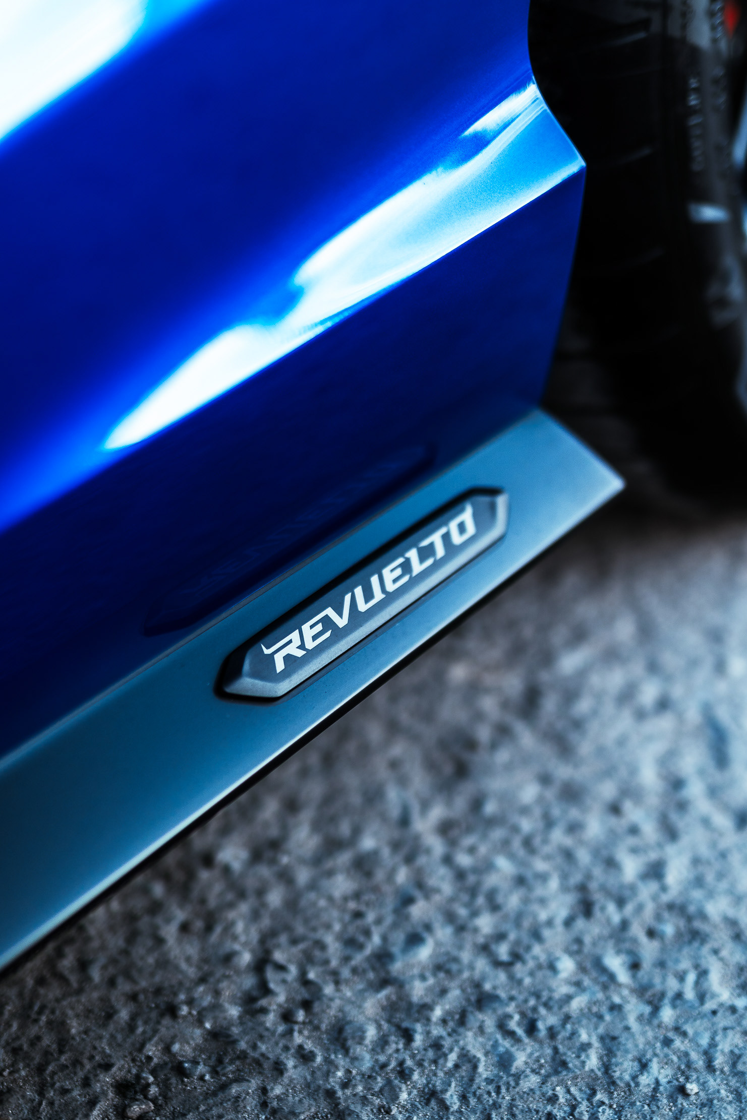 Lamborghini Revuelto door sill badge close-up reading REVUELTO