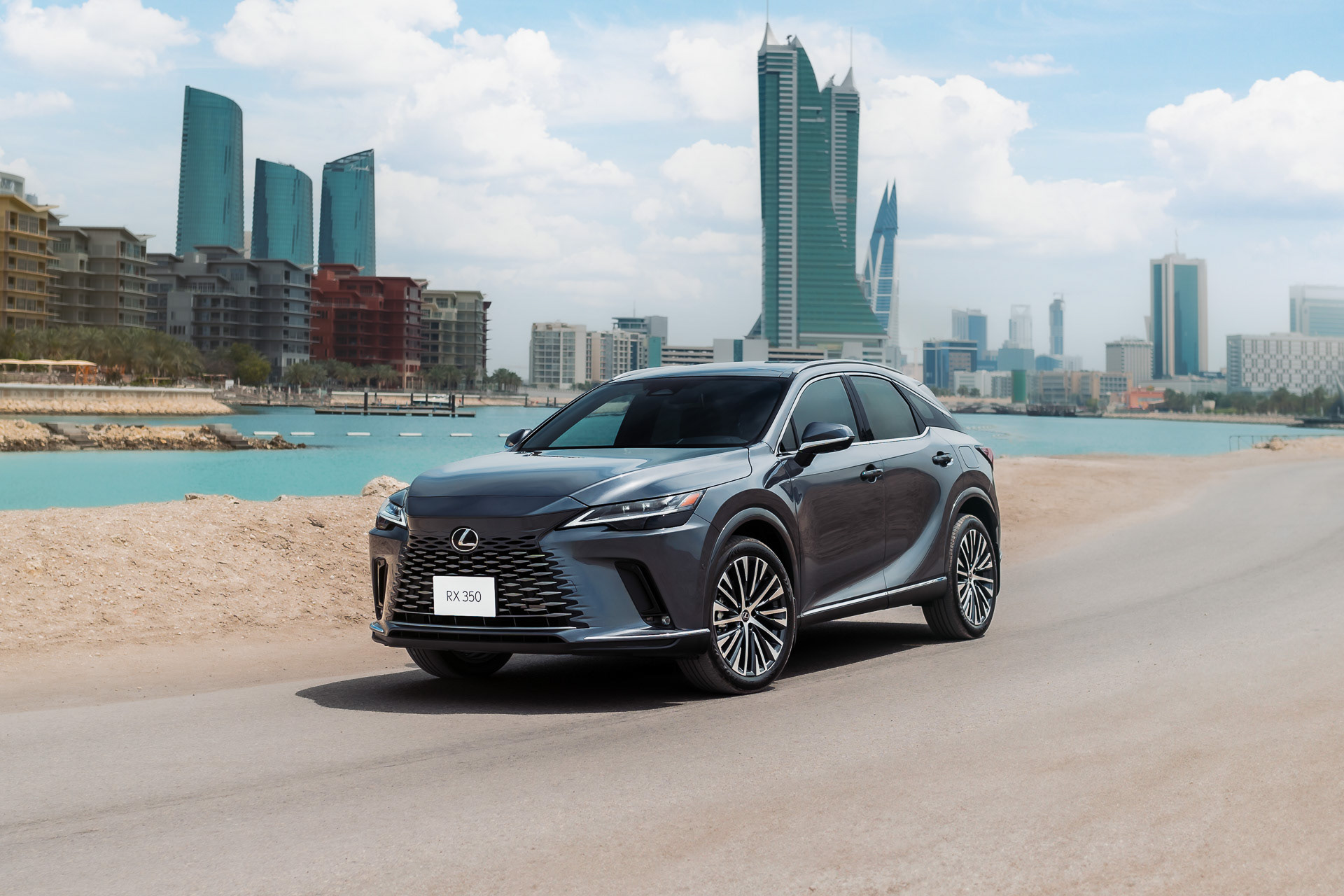 Lexus RX 350 2024 parked near Bahrain Bay with skyline and sea view, daylight scene