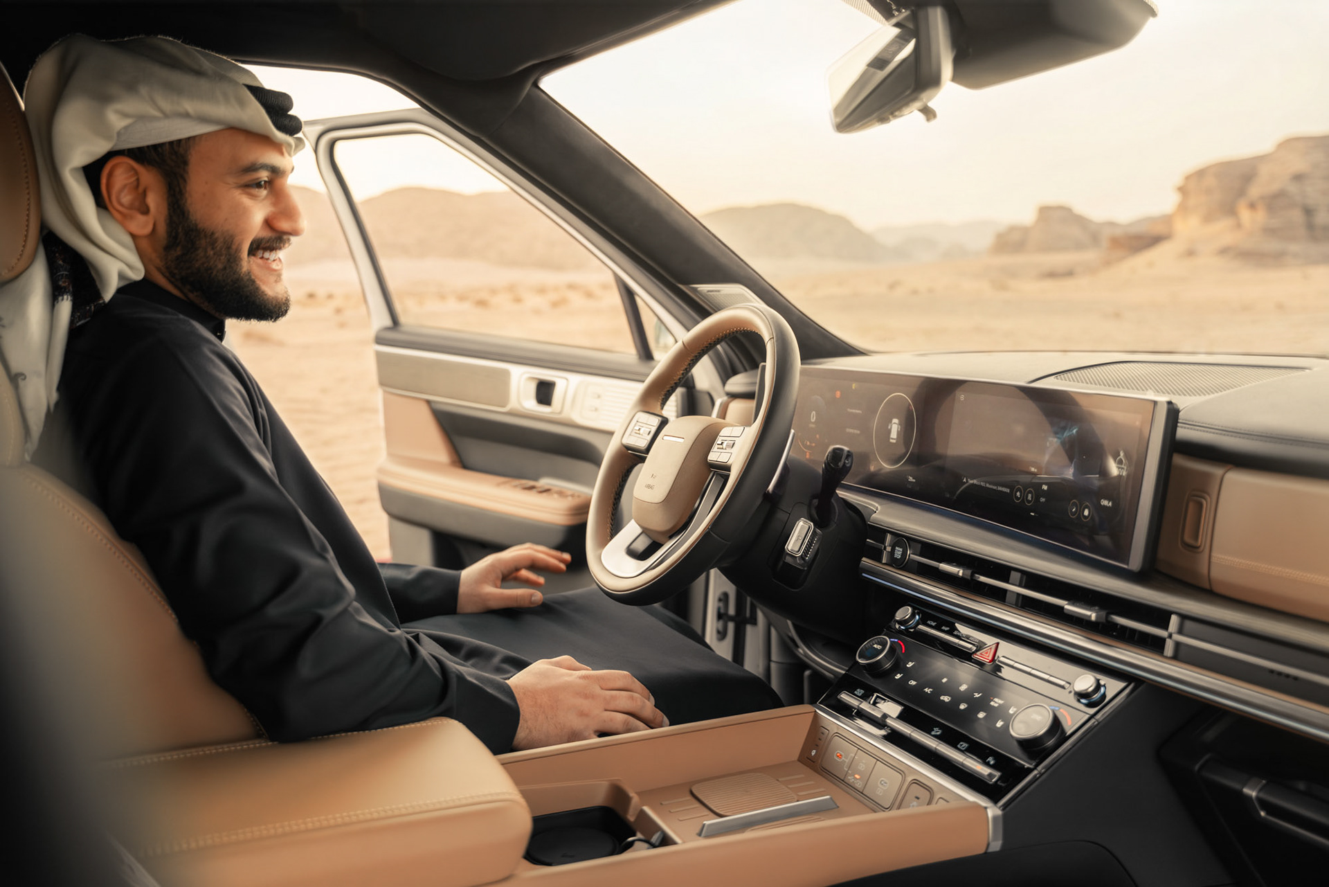 HYUNDAI SANTA FE driver in traditional Gulf dress smiling behind the wheel with the door open to the desert, Bahrain — Shift Mootark
