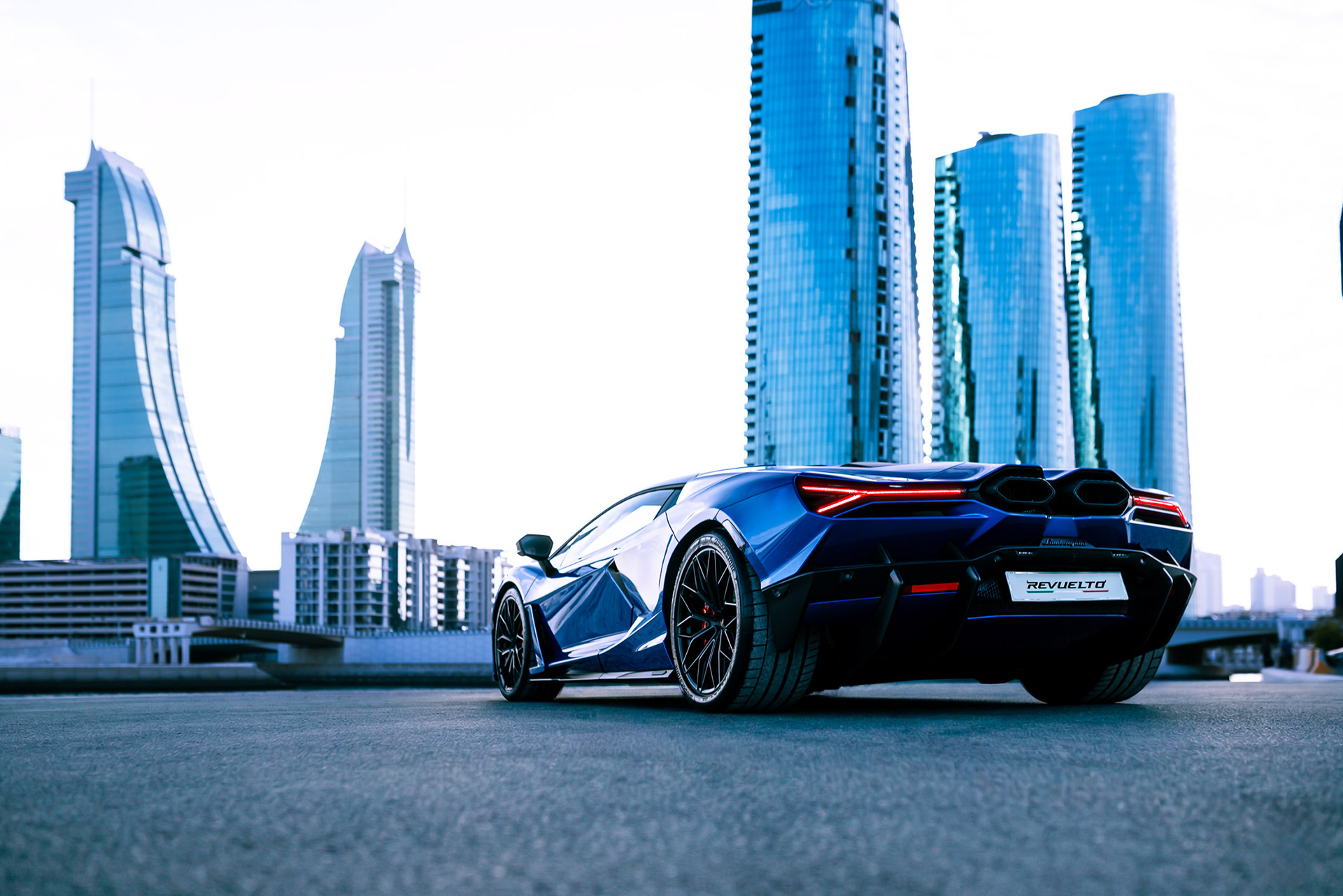 Lamborghini Revuelto rear three-quarter view with Bahrain Bay skyscrapers in the background, Manama