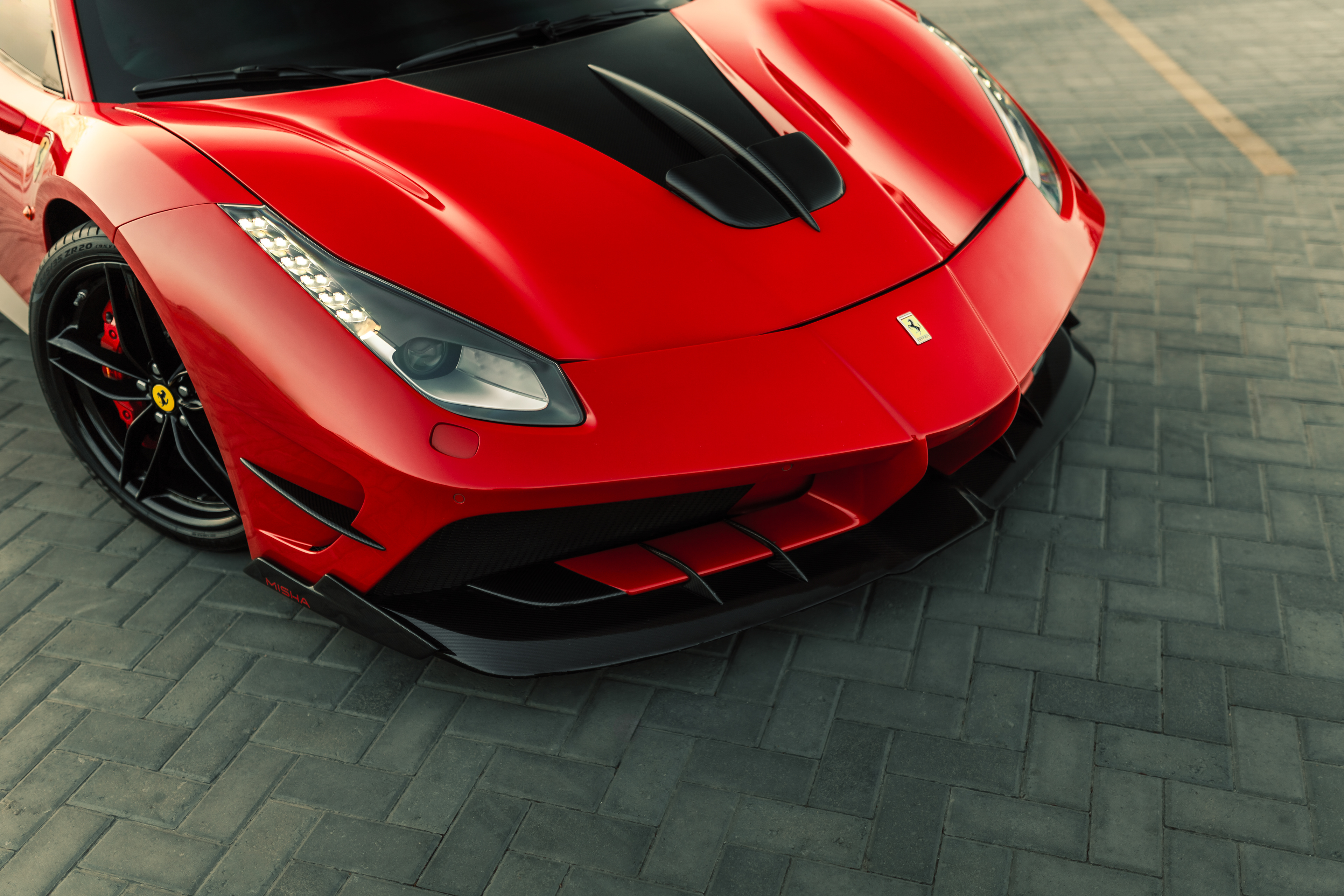 488 GTB Misha, carbon splitter detail, urban backdrop, sunset