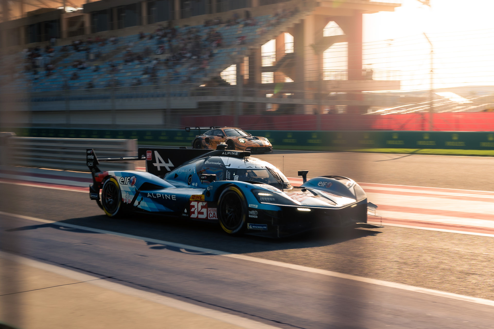 FIA WEC Bahrain — Alpine LMP2 captured at full speed on the main straight during sunset at Bahrain International Circuit.