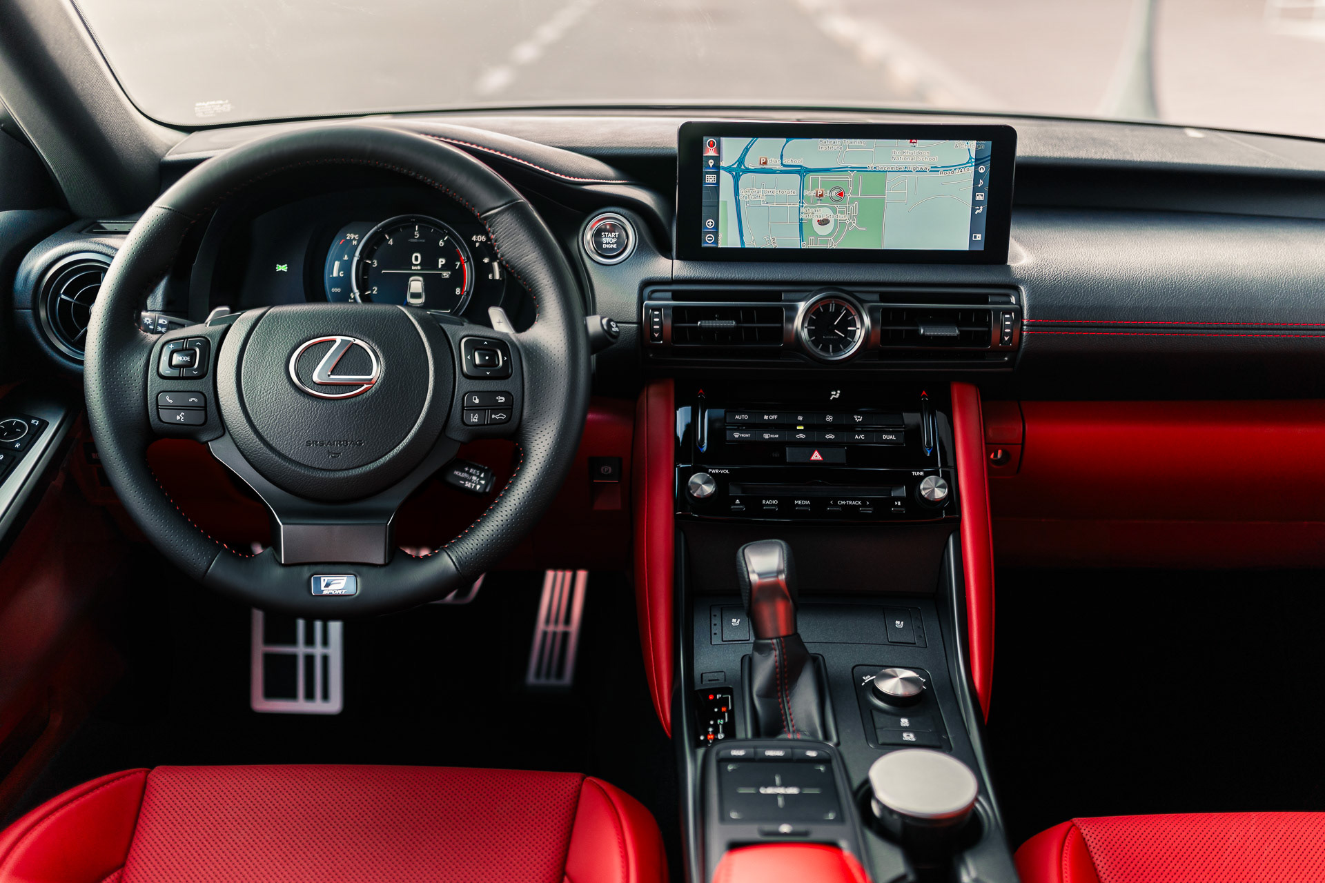 Lexus IS 350 F SPORT interior with red seats and steering wheel detail under natural light