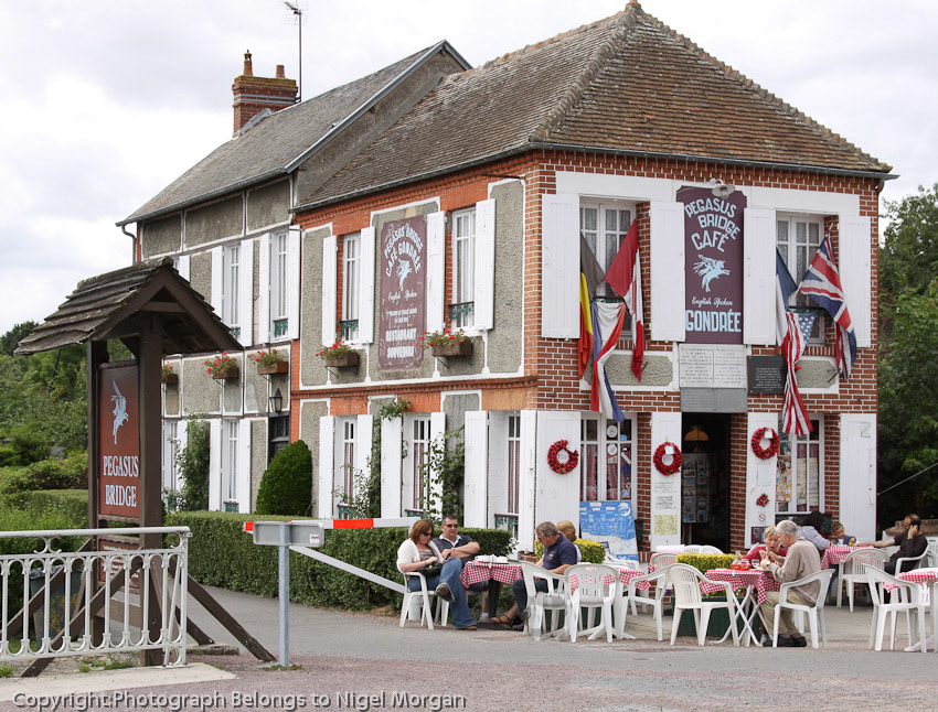 Very soon the café was taken by the 7th Battalion to serve as their Headquarters and Regimental Aid Post. Georges disappeared into the garden to dig up no fewer than ninety-eight bottles of champagne that he had buried in June 1940, and very soon the scene was one of great celebration as free drinks were handed out to all and sundry.