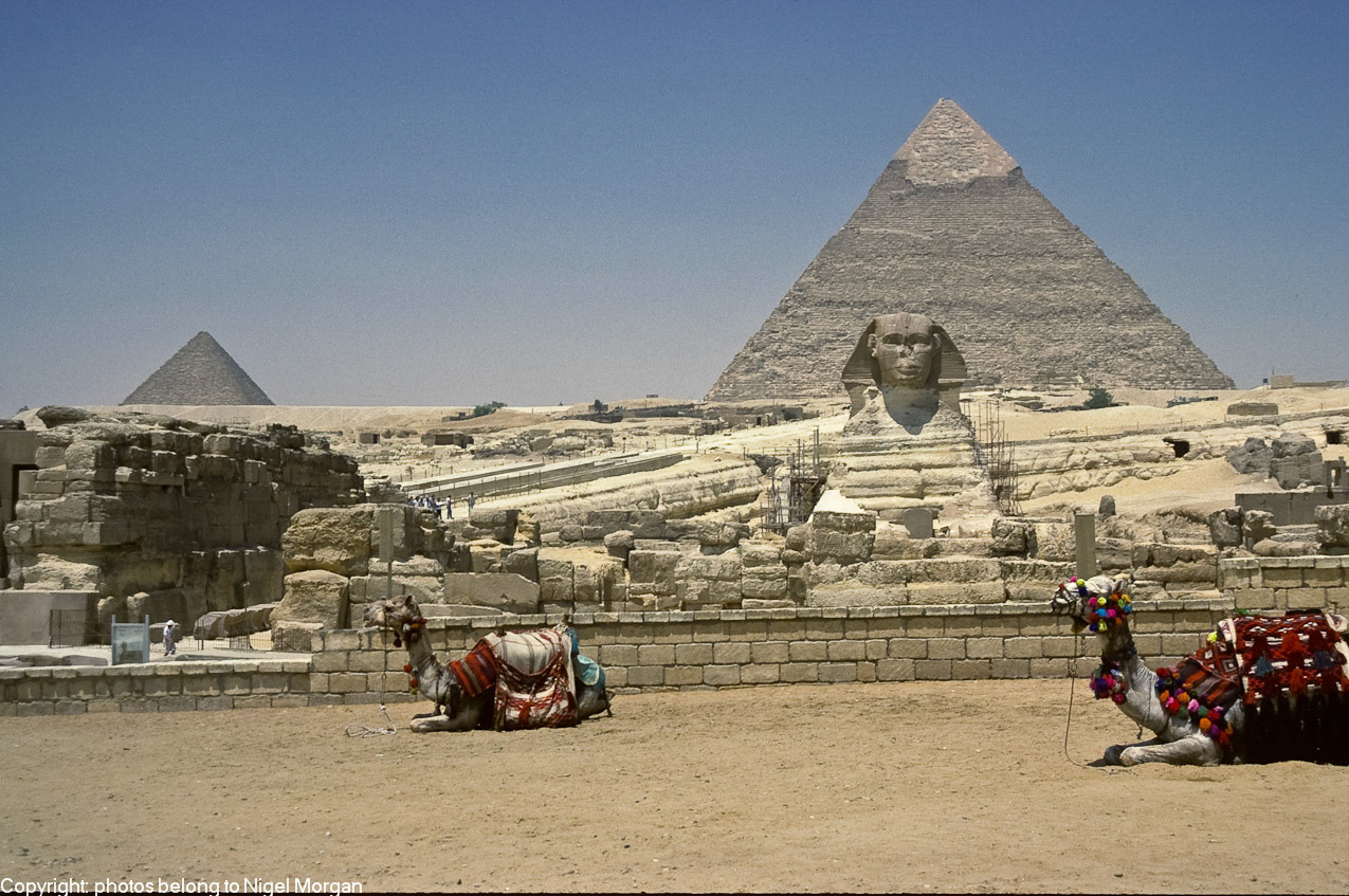 Sphinx with Pyramid of Chephren behind. Small pyramid on left is the Pyramid of Mykerinos