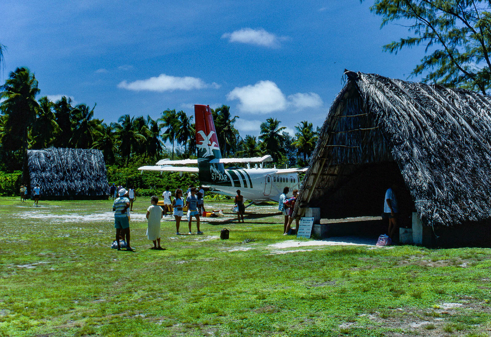 Island airport with straw hut terminals.