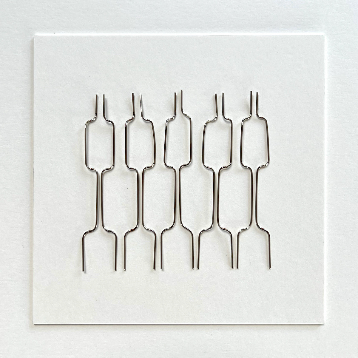 10 lines, 14th August, paperclips on paper