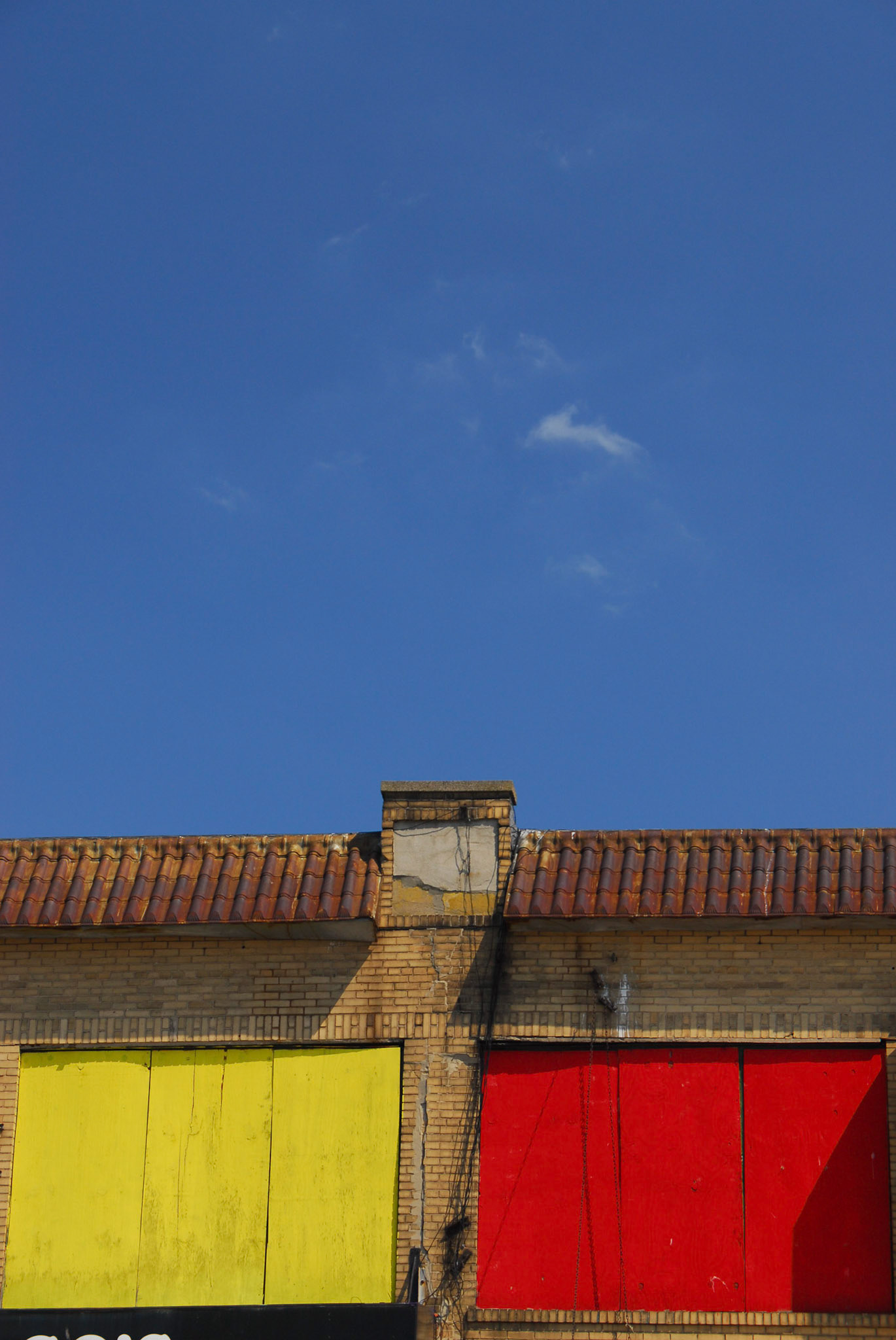 Yelloy and red windows against a blue sky