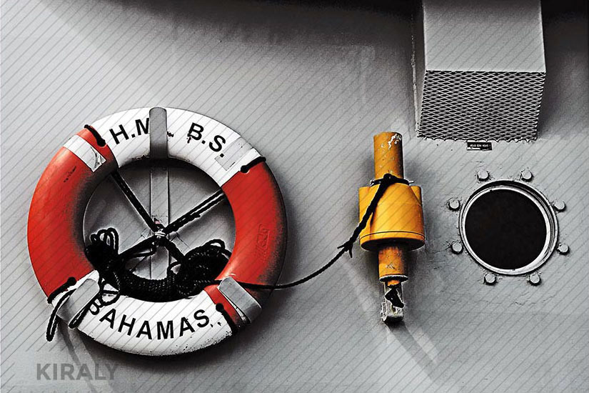 Photo of side of boat showing safety float ring and port hole