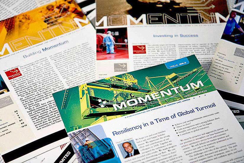 Enlarged view of a pile of newsletters for a shipping logistics company