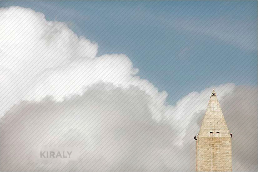 Workers climbing on side of tip of the Washington Monument