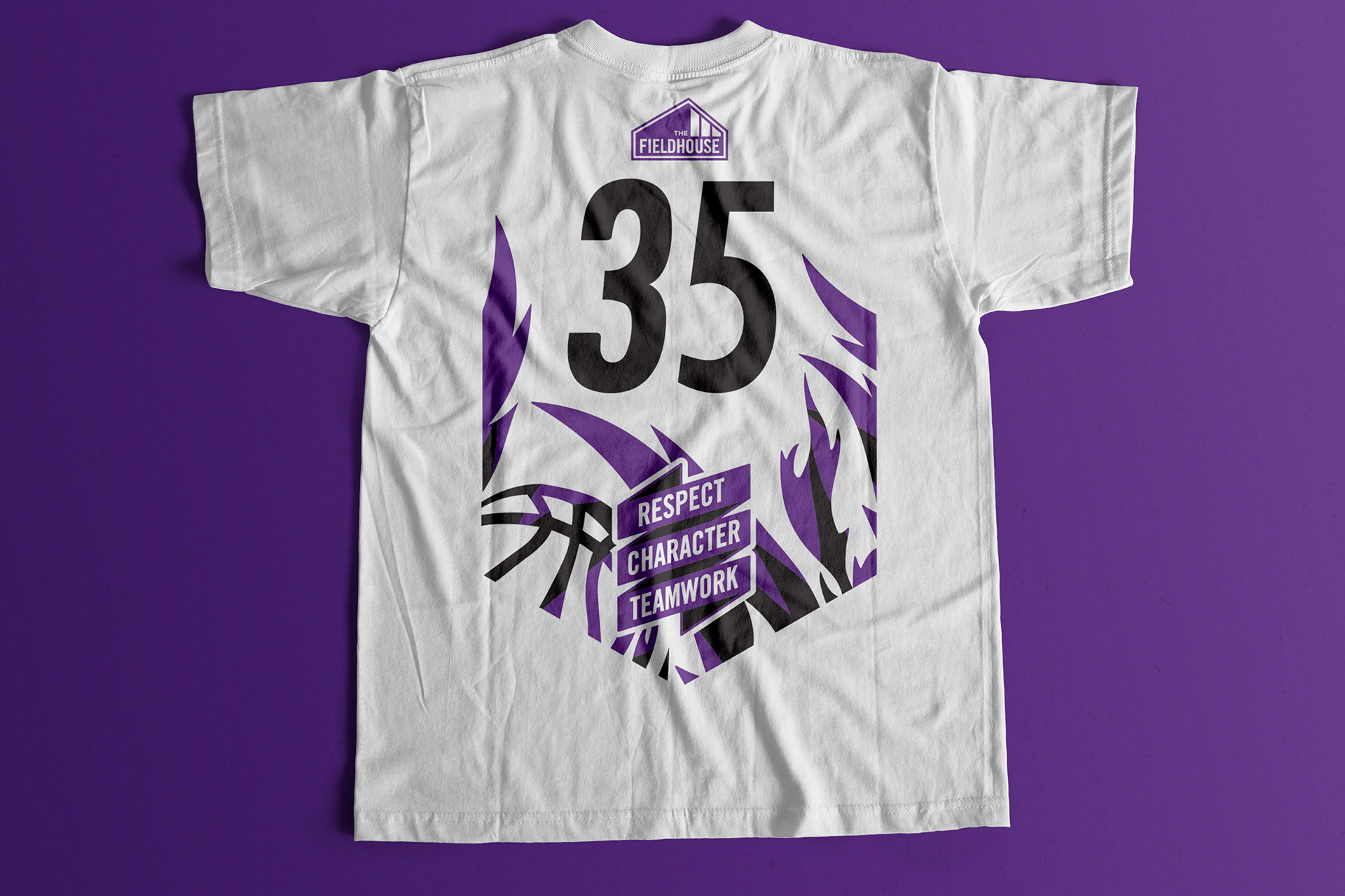 Back of white shirt featuring player number and illustrative flames along with a slogan