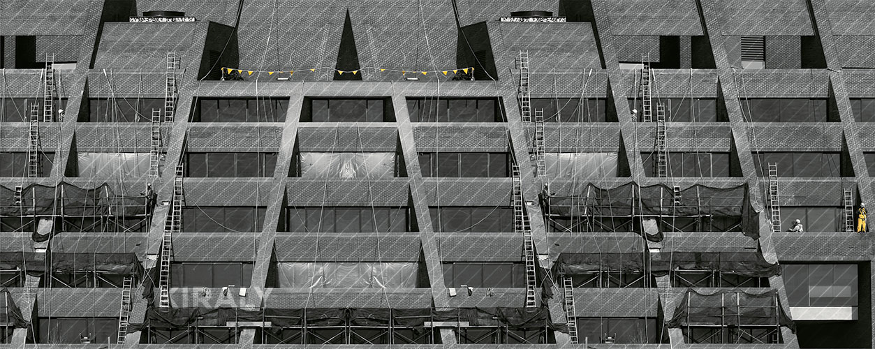 Photo of a mirrored image of a building that is undergoing renovation