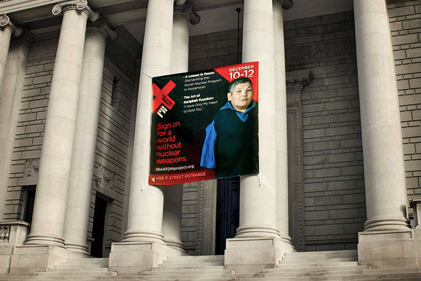 Exterior hanging fabric signage announcing artist's exhibit