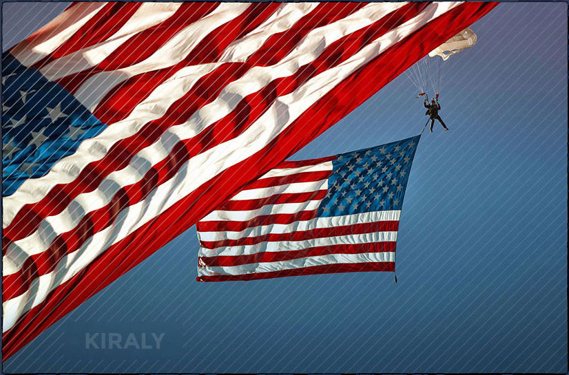 Photo of military vets parachuting with an enormous American flag trailing them