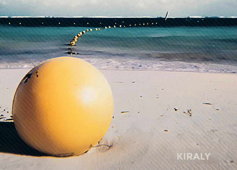 Beach shoreline with a floating line of attached circular yellow markers