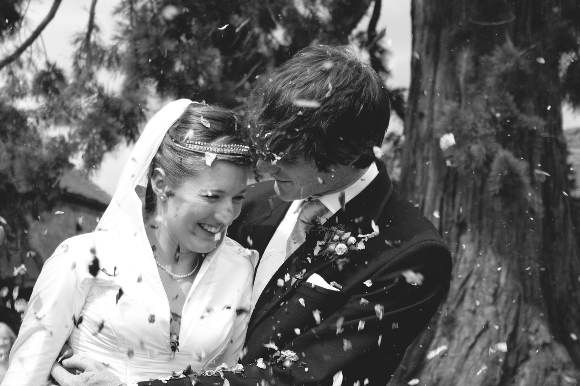 The happy couple share a moment as confetti swirls around them