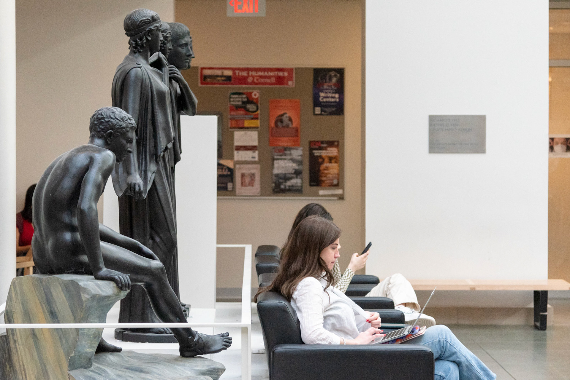 Students study under the statues of Goldwin Smith Hall, March 17, 2022. (Ming DeMers/Sun Contributor)