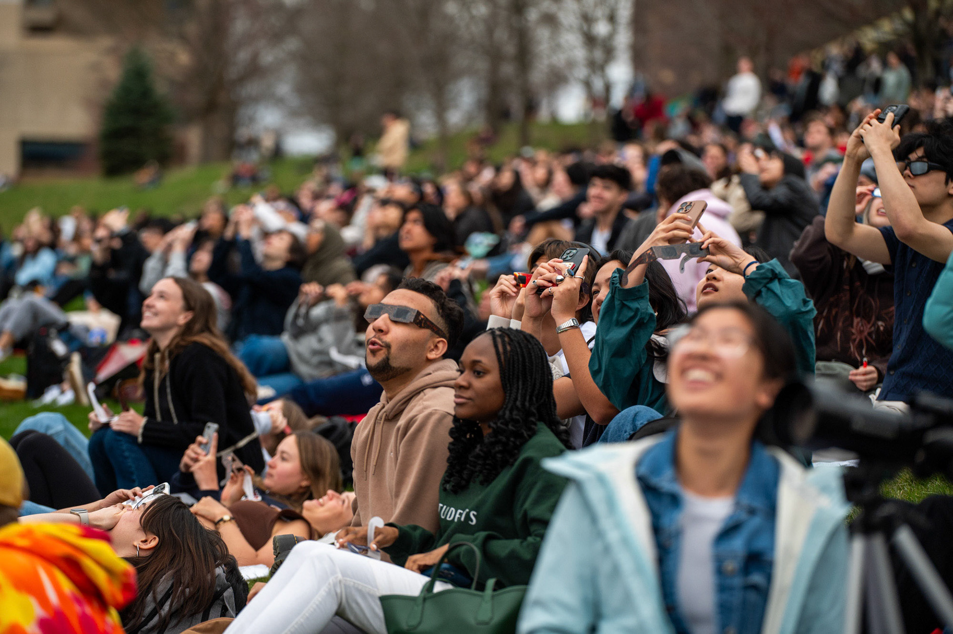 Students caught glimpses of the solar eclipse on Libe Slope, April 8th, 2024. (Ming DeMers/Sun Senior Photo)