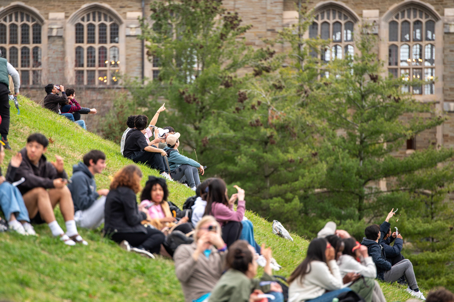 Students caught glimpses of the solar eclipse on Libe Slope, April 8th, 2024. (Ming DeMers/Sun Senior Photo)