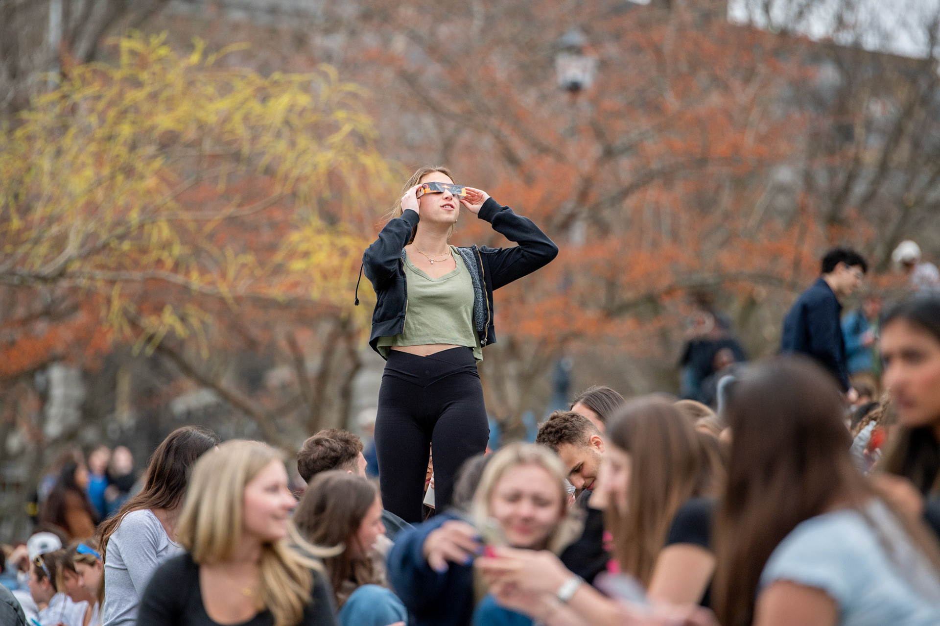 Students caught glimpses of the solar eclipse on Libe Slope, April 8th, 2024. (Ming DeMers/Sun Senior Photo)